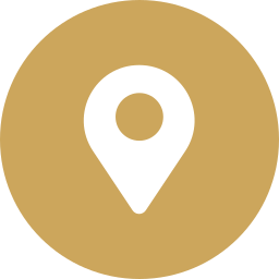A gold circular background with a white location pin icon in the center.