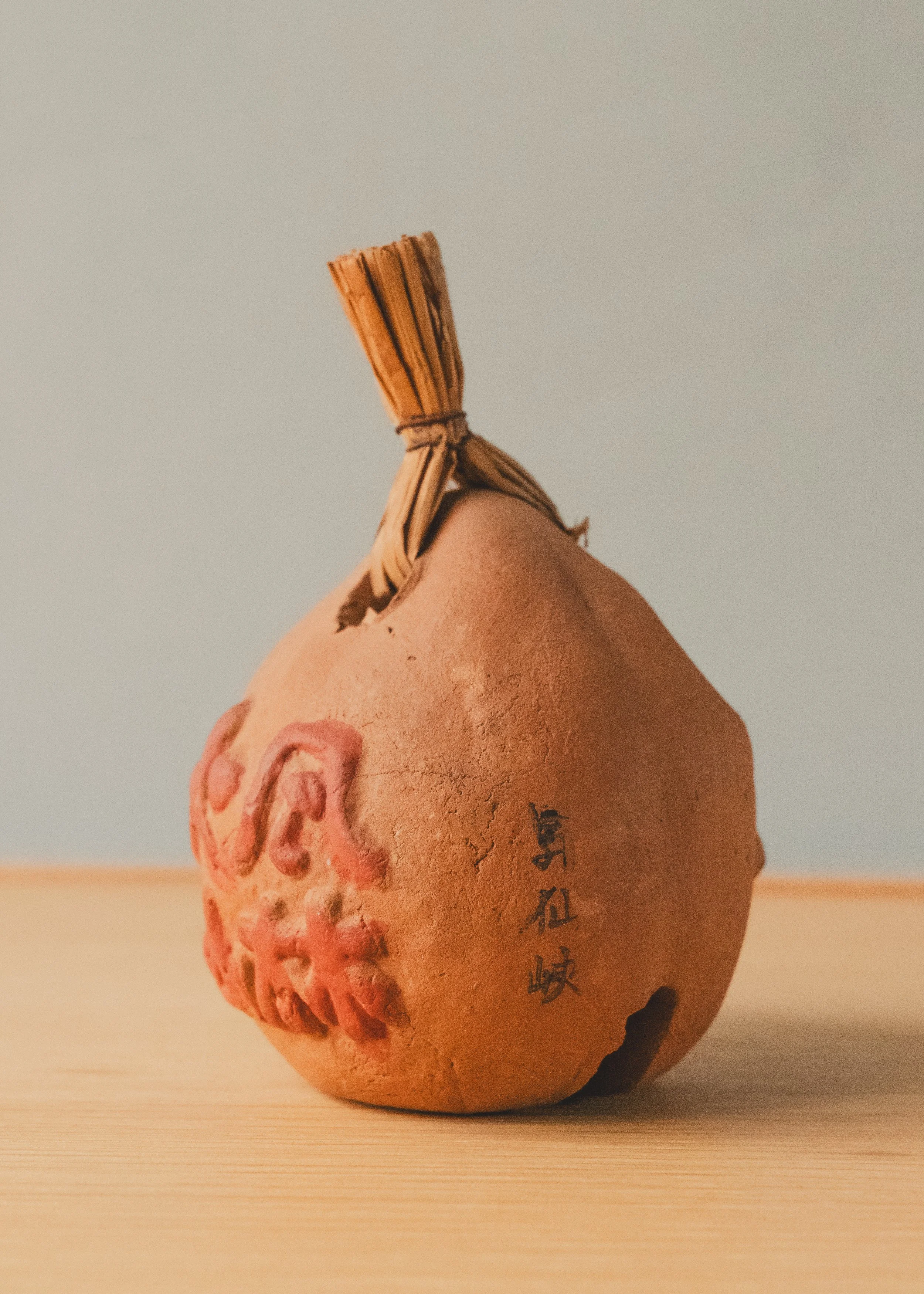 Close-up of the Shosenkyo spiritual site origin marking and hand-embossed kanji on the UNGLAZED TALISMAN 1970. Authentic provincial archival specimen.