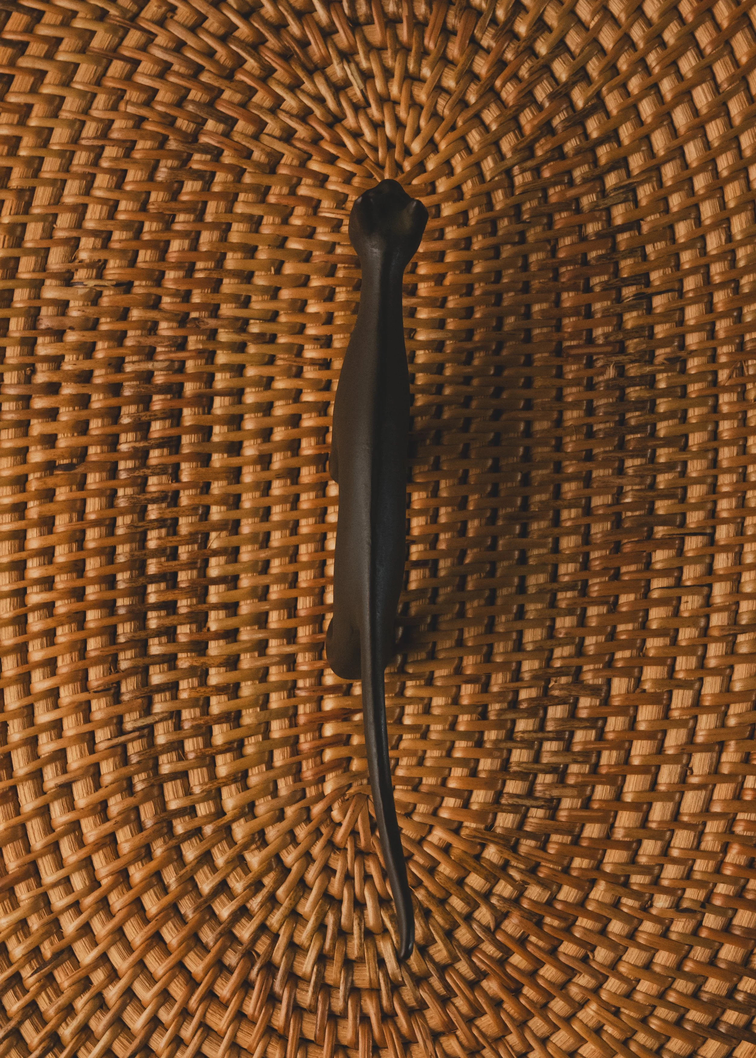 Rear view of a solid iron feline figurine showing the traditional "Sabiiro" oxidized patina. Sleek modernist form doubling as a paperweight or ring valet.