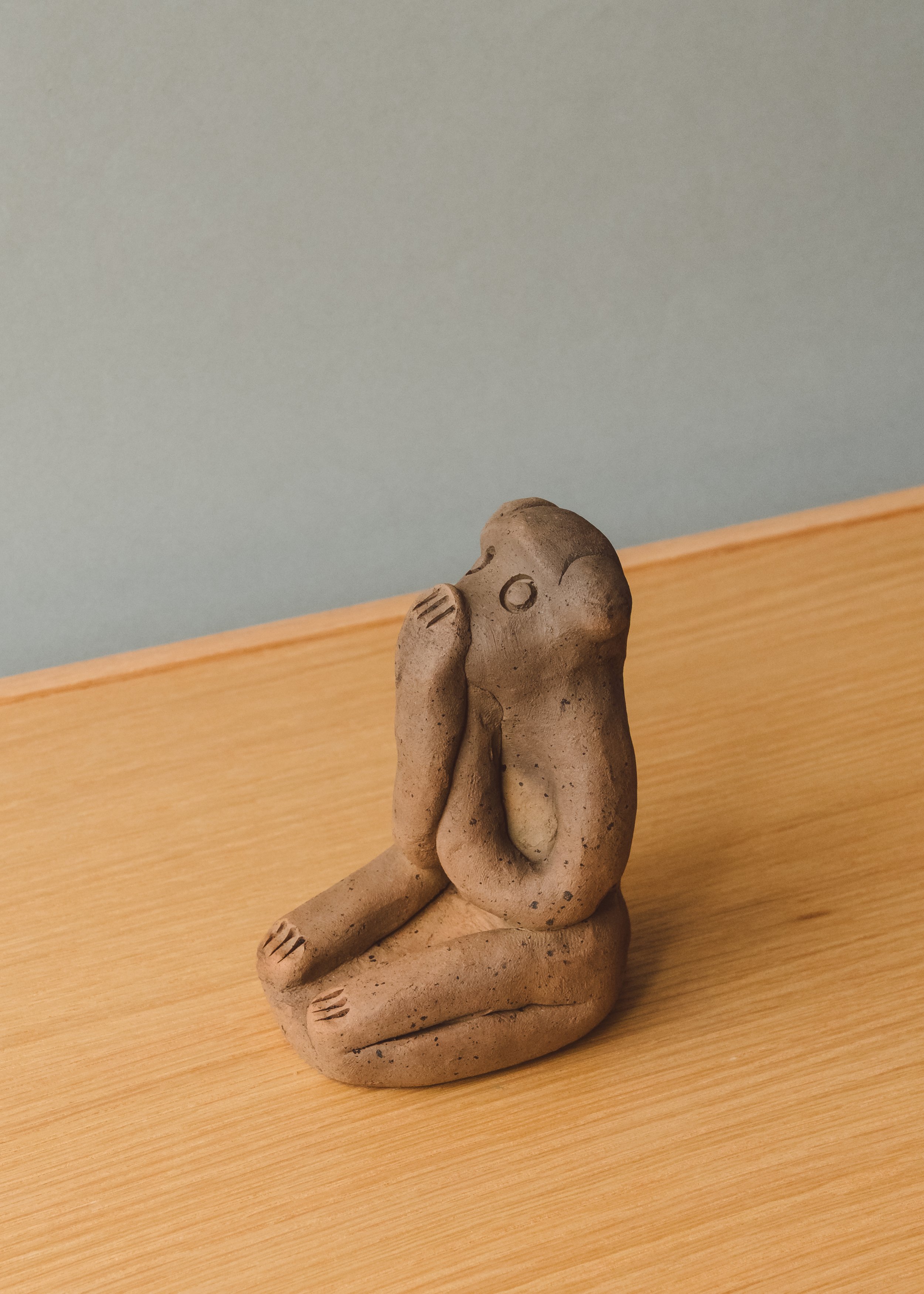 Vintage Japanese folk art "Speak No Evil" monkey talisman. The Brutalist and minimalist clay form functions as an intellectual conversation piece for contemporary desktop styling.