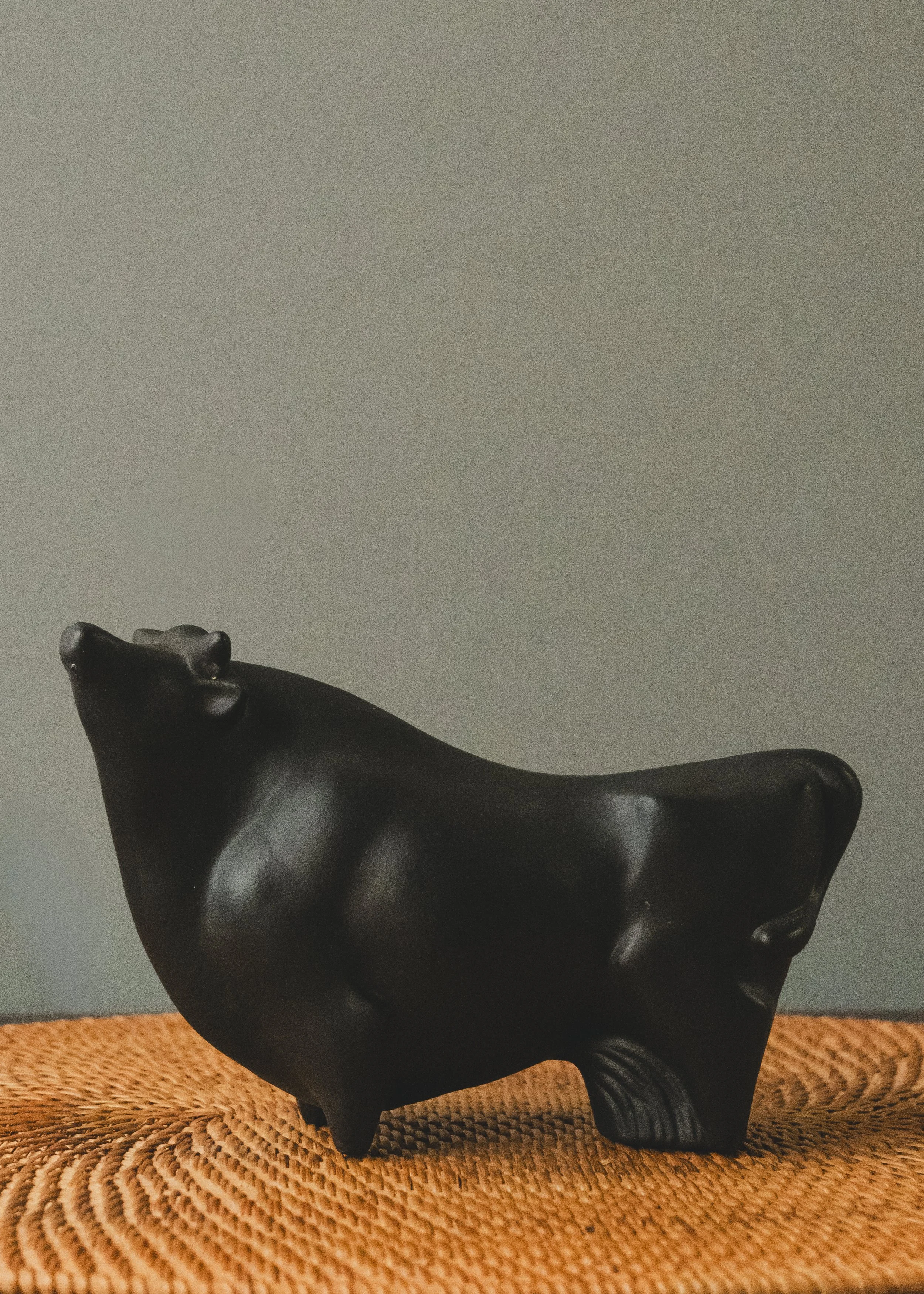 Handcrafted Japanese black bull sculpture from 1968. A tactile, weighted desk accessory with a permanent, chip-resistant matte-black finish. Perfect for minimalist shelves.