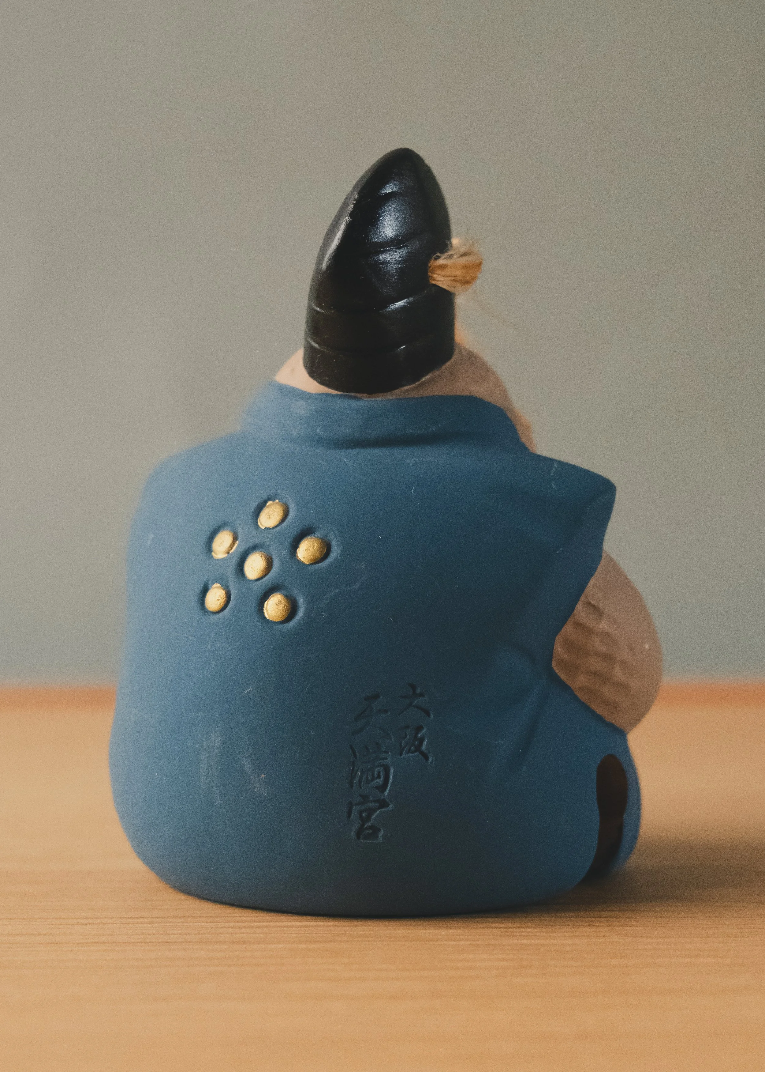 Close-up of the hand-incised 'Osaka Tenmangu' signature on the back of the clay sculpture. Crucial evidence of its sacred origin and archival provenance.