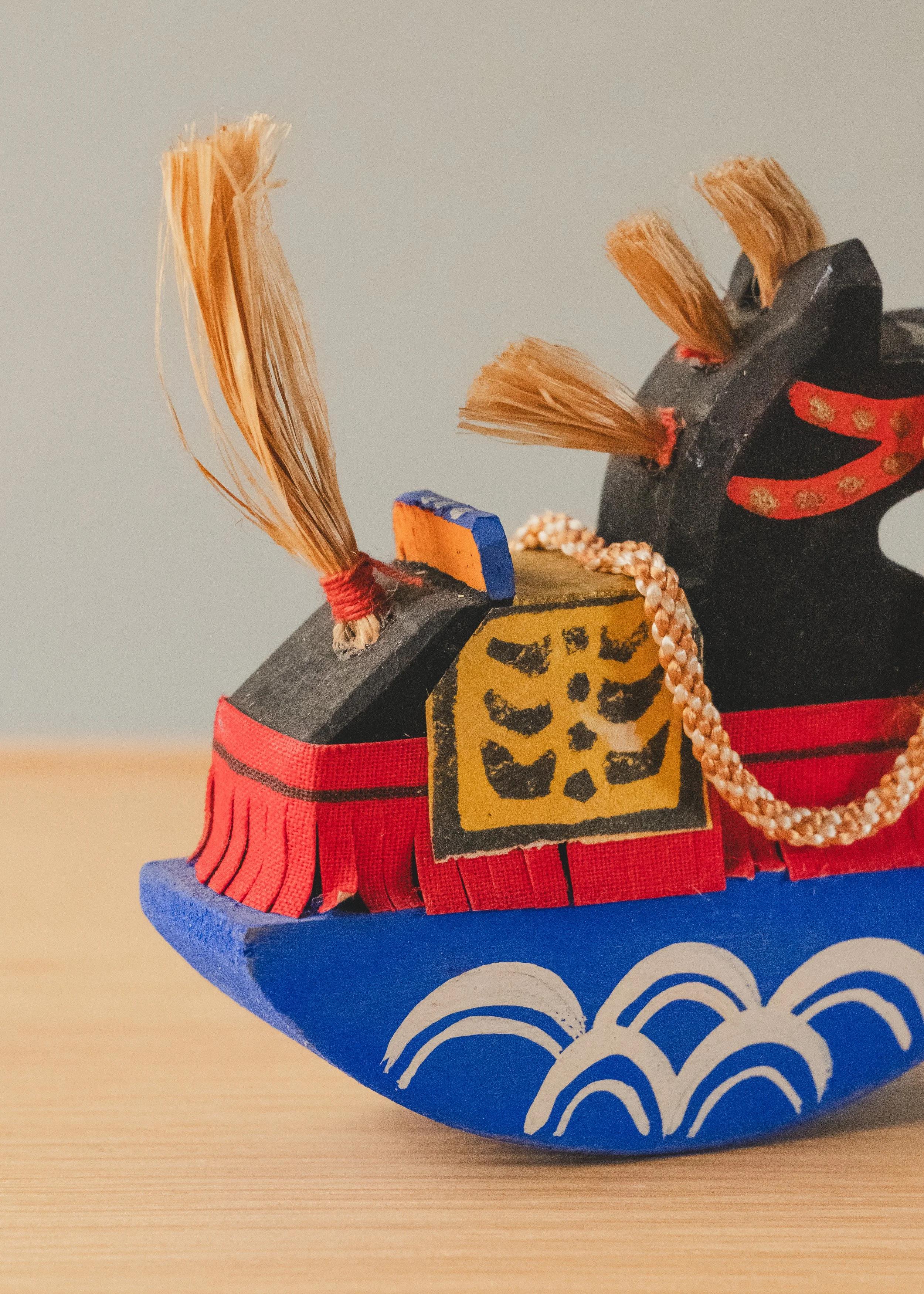 Texture detail of THE VANGUARD STALLION 1930. Tactile unglazed finish on paulownia wood, showing the physical traces of historical craftsmanship.