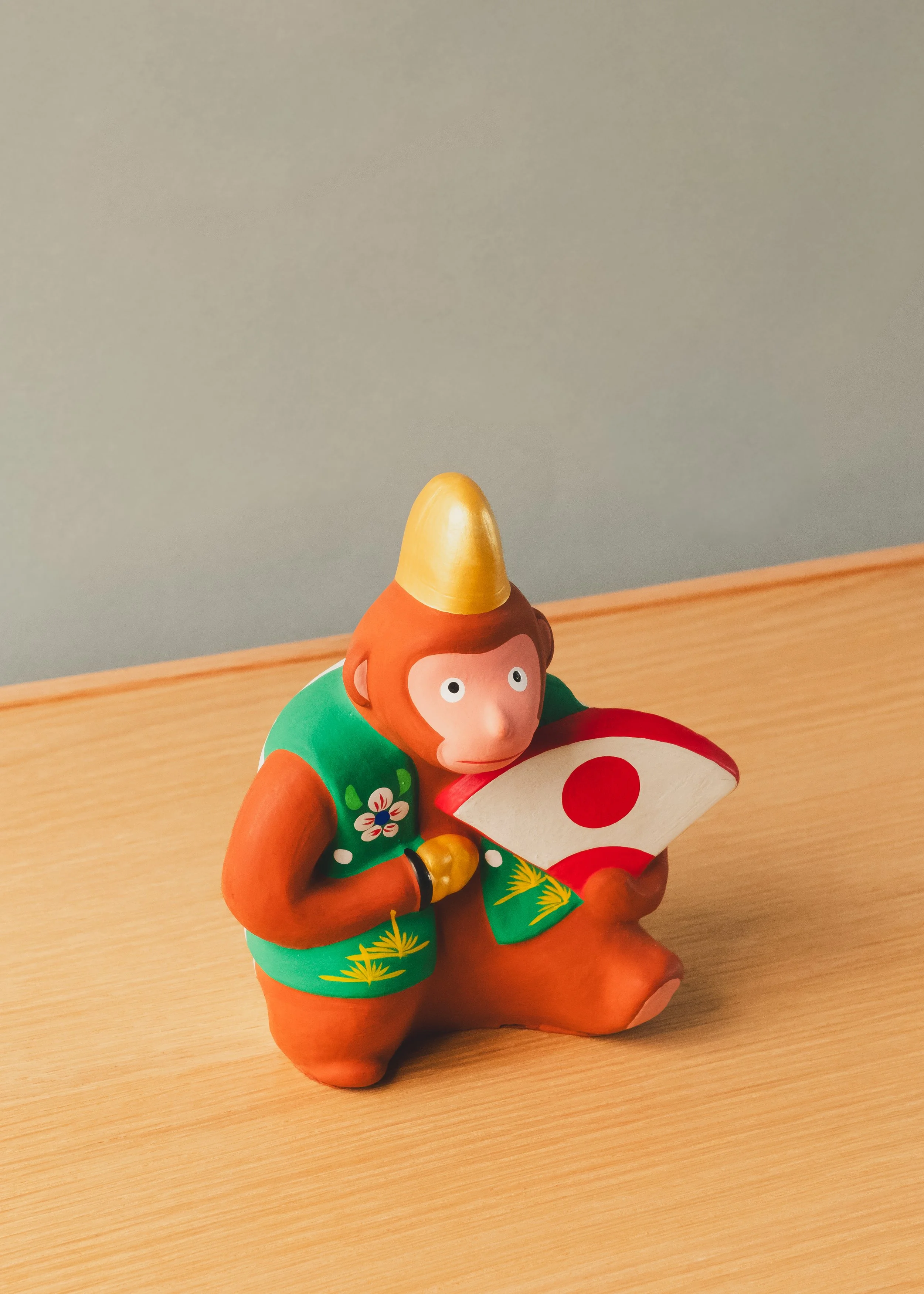 Hanamaki Ningyo clay monkey figurine. 1974 Japanese folk craft (Mingei) showcasing vibrant hand-painted robes and a celebratory fan.