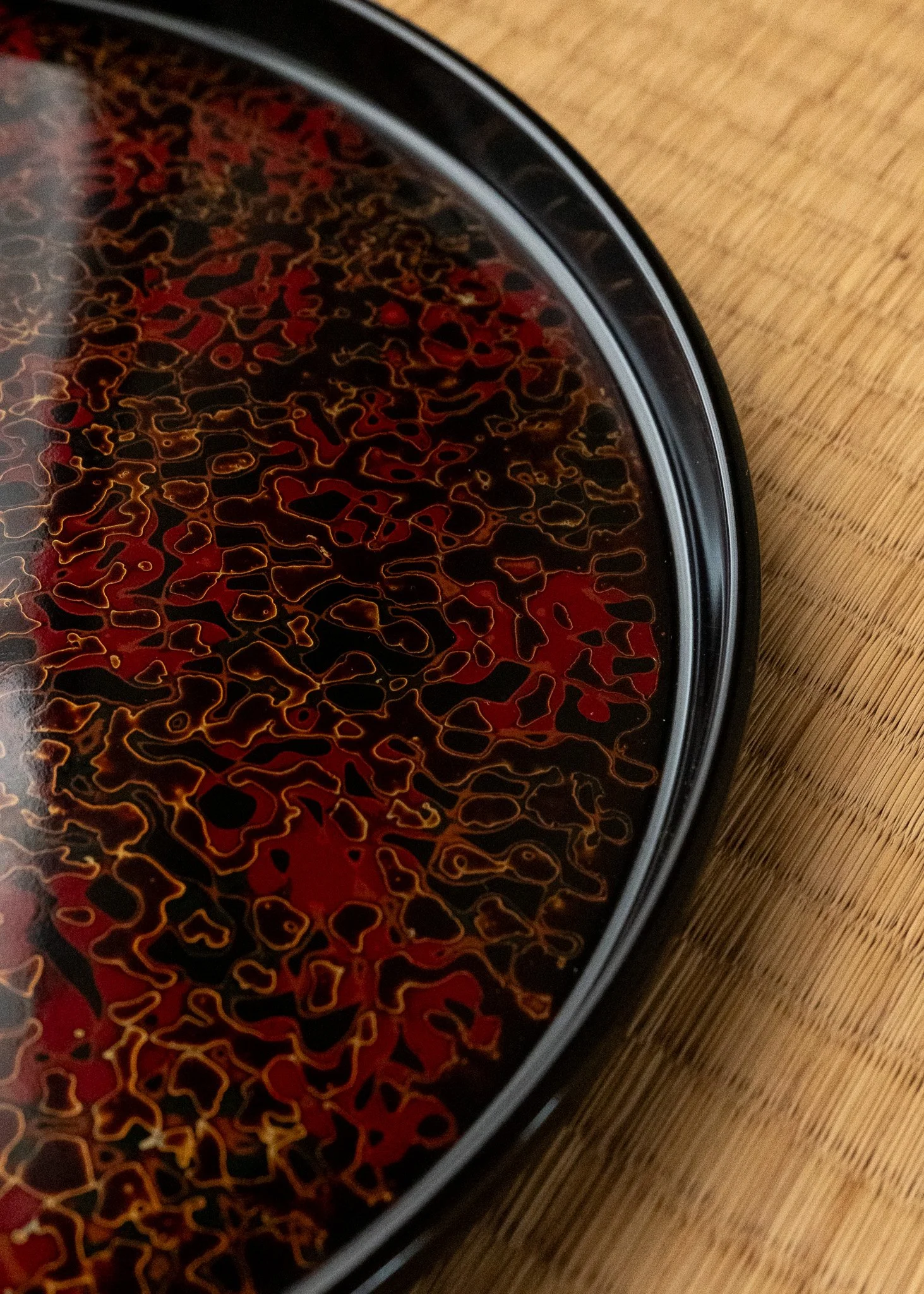 Macro detail of Tsugaru-nuri urushi lacquer pattern. Close-up showing the complex cellular topography of the 'Kara-nuri' technique on a vintage Japanese tray.
