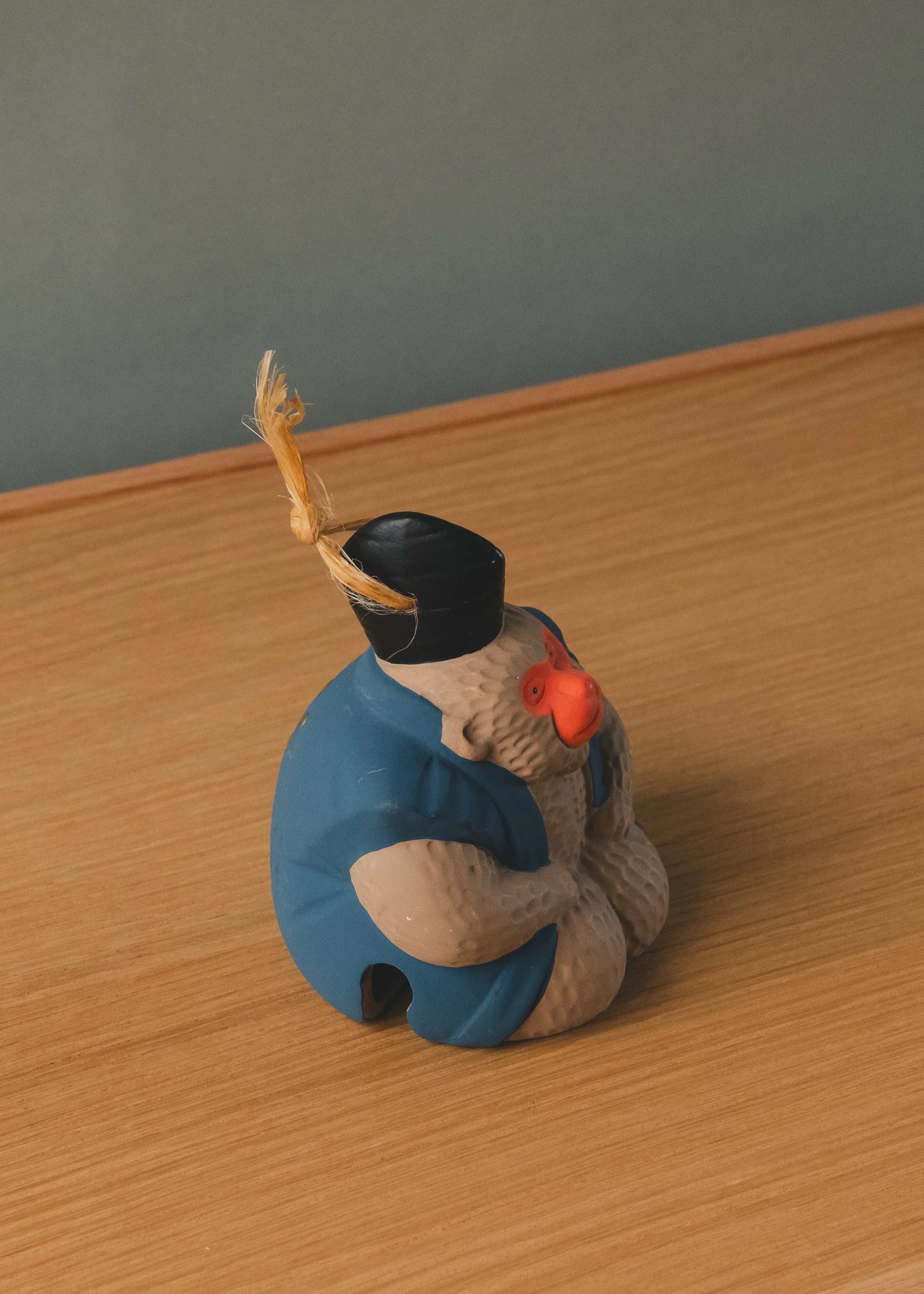 Side profile of a Japanese temple herald wearing an Eboshi (shrine hat). A tactile archival specimen with a silent expression of 1,500 years of cultural weight.
