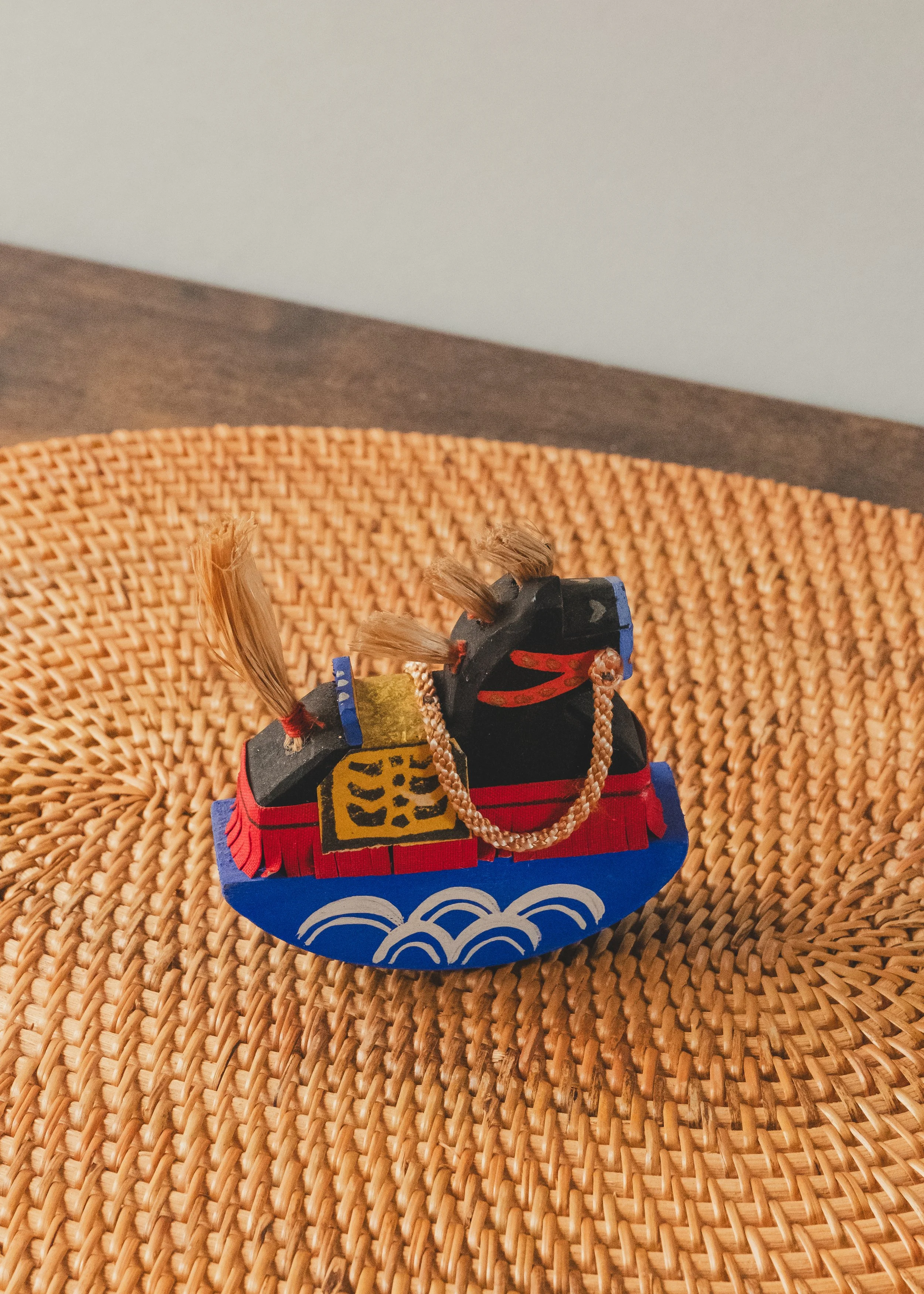 Rear perspective of THE VANGUARD STALLION 1930, a hand-carved vintage Japanese Paulownia wood horse with natural straw tail and a blue rocking pedestal.