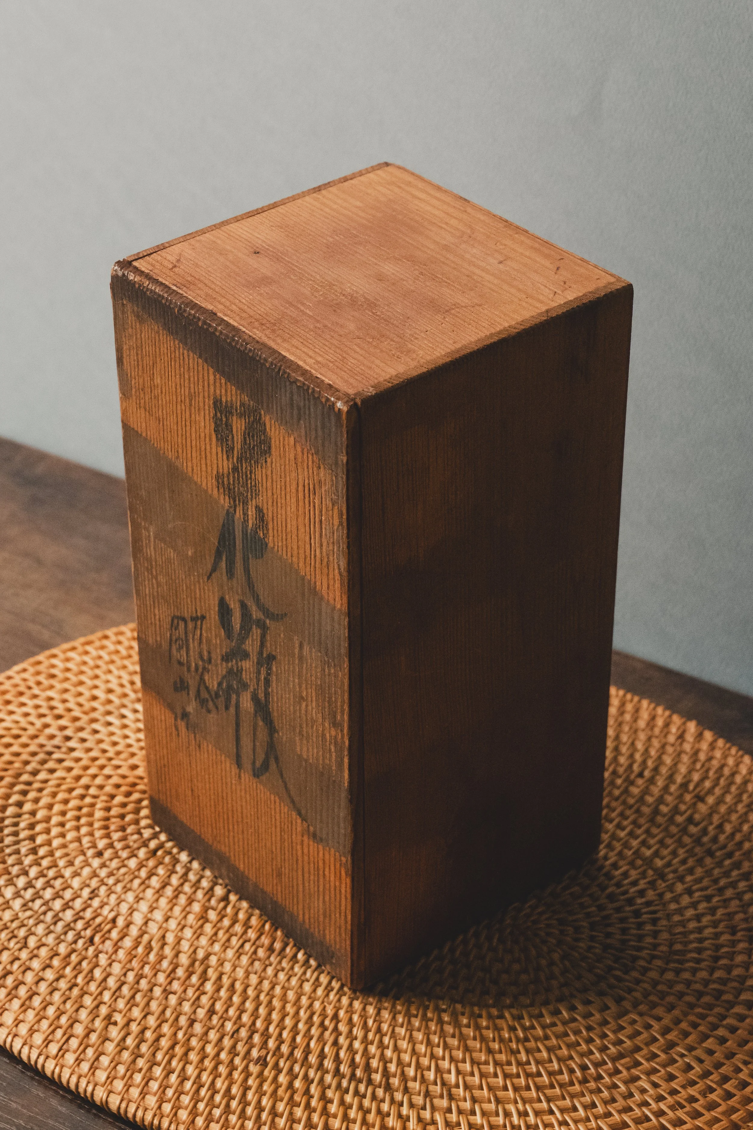 Antique Japanese porcelain vase placed inside an original artisan-signed Paulownia wooden storage case (Tomobako), authentic gallery provenance from Japan.