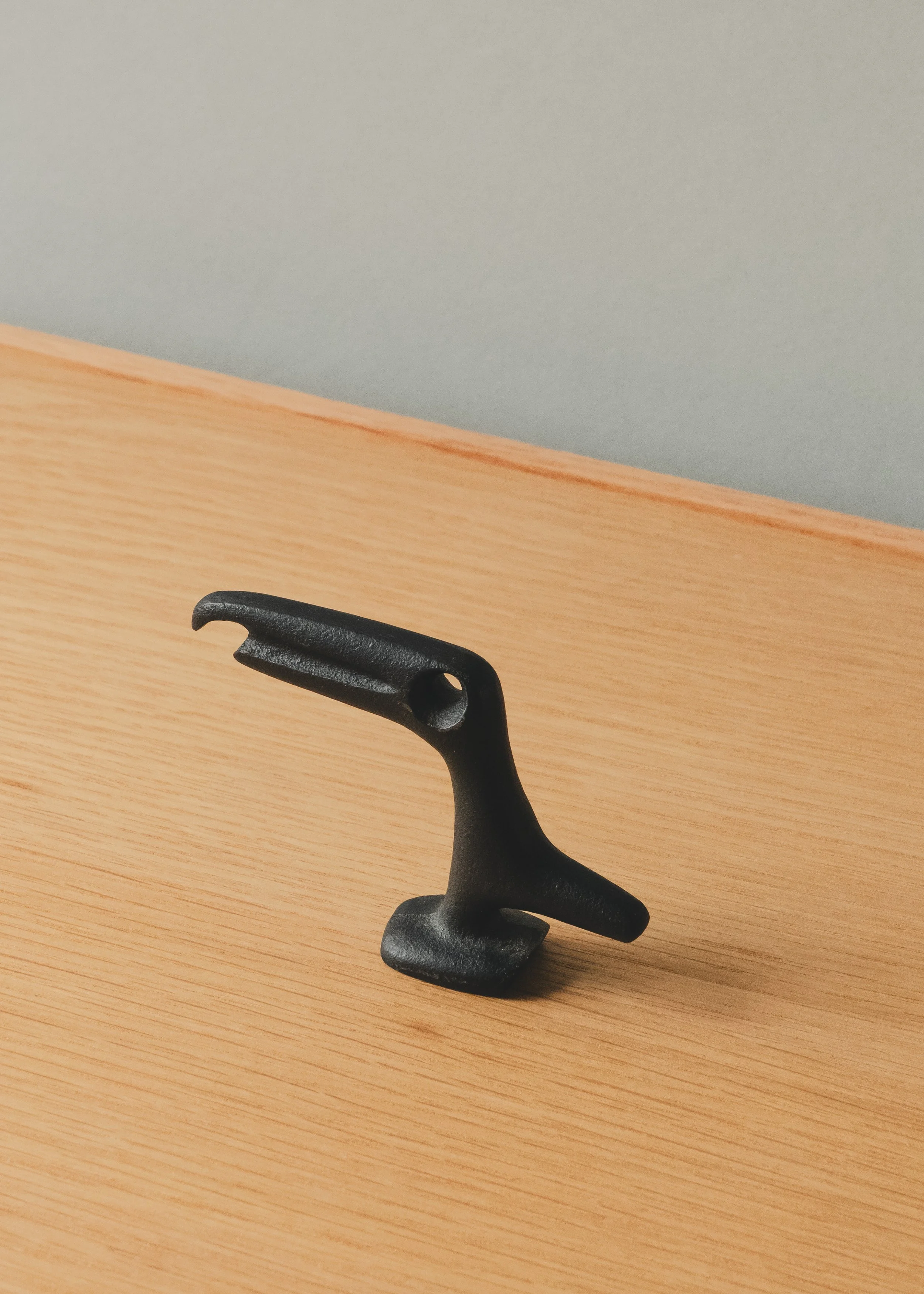 Perspective view of FERROUS RAVEN 1970 (Vertical), showing the textured matte black surface and hand-cast material integrity of authentic Nambu Tekki from Iwate, Japan.