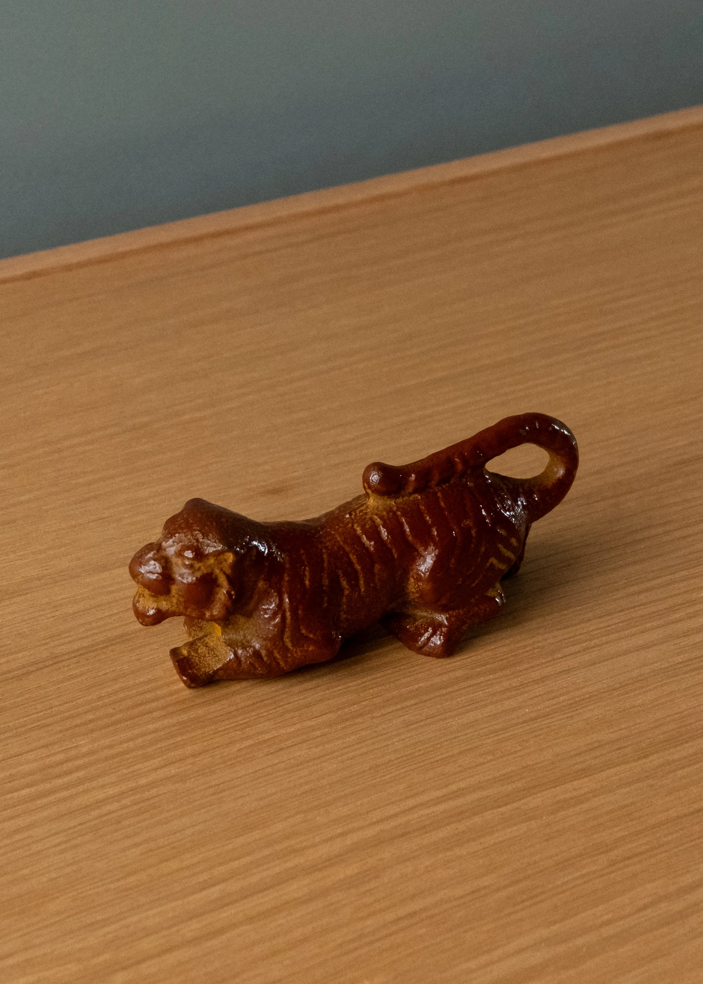 Antique Nambu Tekki iron tiger bottle opener and sculpture. Detail of the celestial stripe texture in reddish-brown vitrified luster. Handmade Japanese desk anchor.