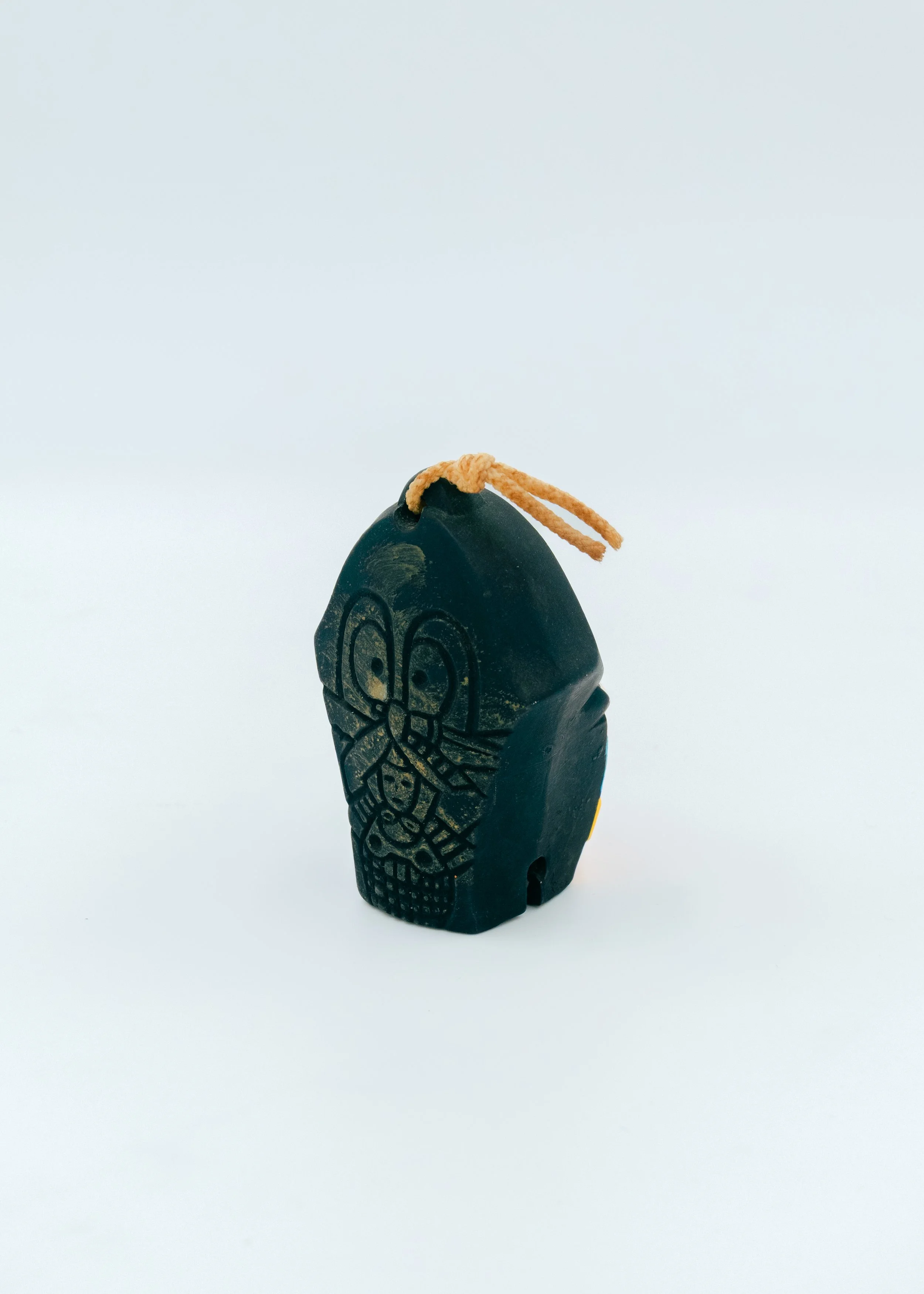 Side profile of a Japanese ritual bell mascot (Dorei), showing the primitive yet sophisticated sculptural depth of the 500-year-old Hirado kite-art tradition.