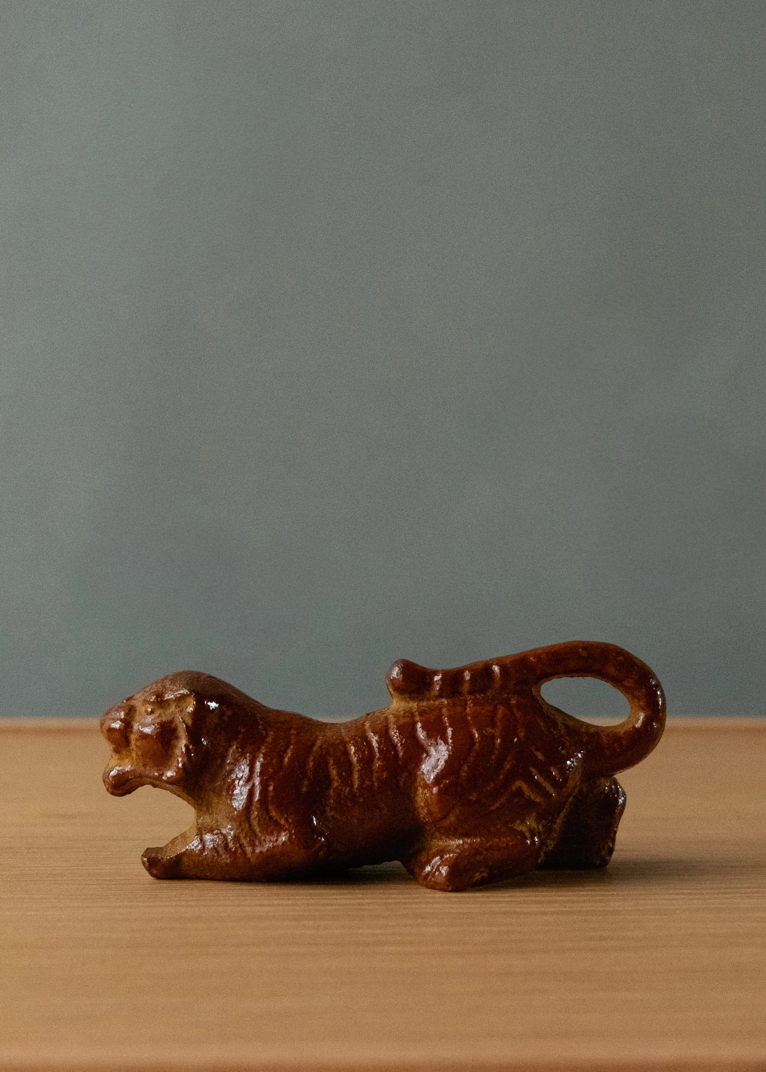 Side profile of an anonymous 1974 iron zodiac tiger specimen. Showing the organic "latent tension" pose captured in hand-poured Nambu ironware from Japan.