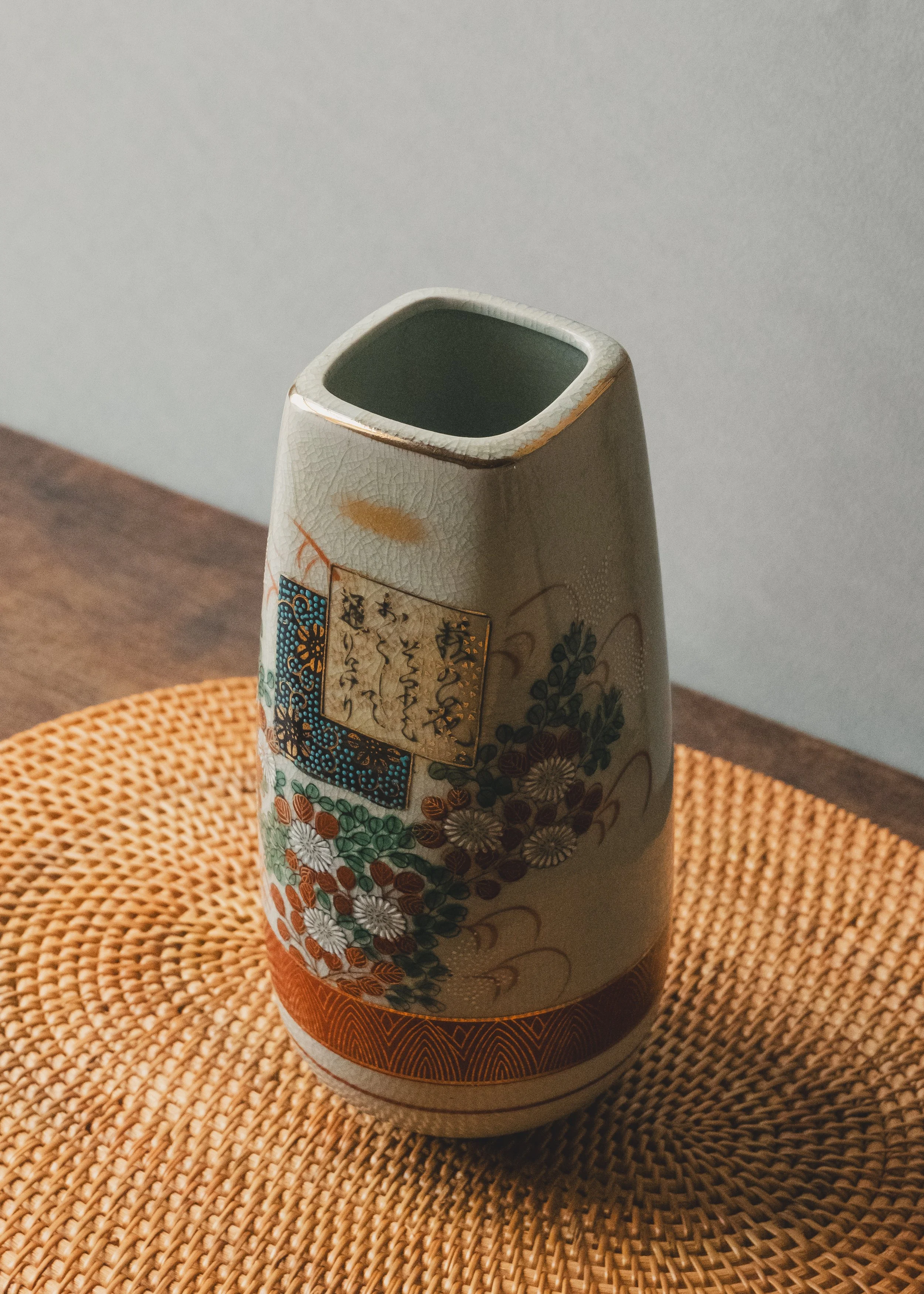 Exquisite vintage Japanese Kinrande ceramic flower vase with hand-painted gold waka poetry script and colorful floral patterns on white crackle glaze surface.