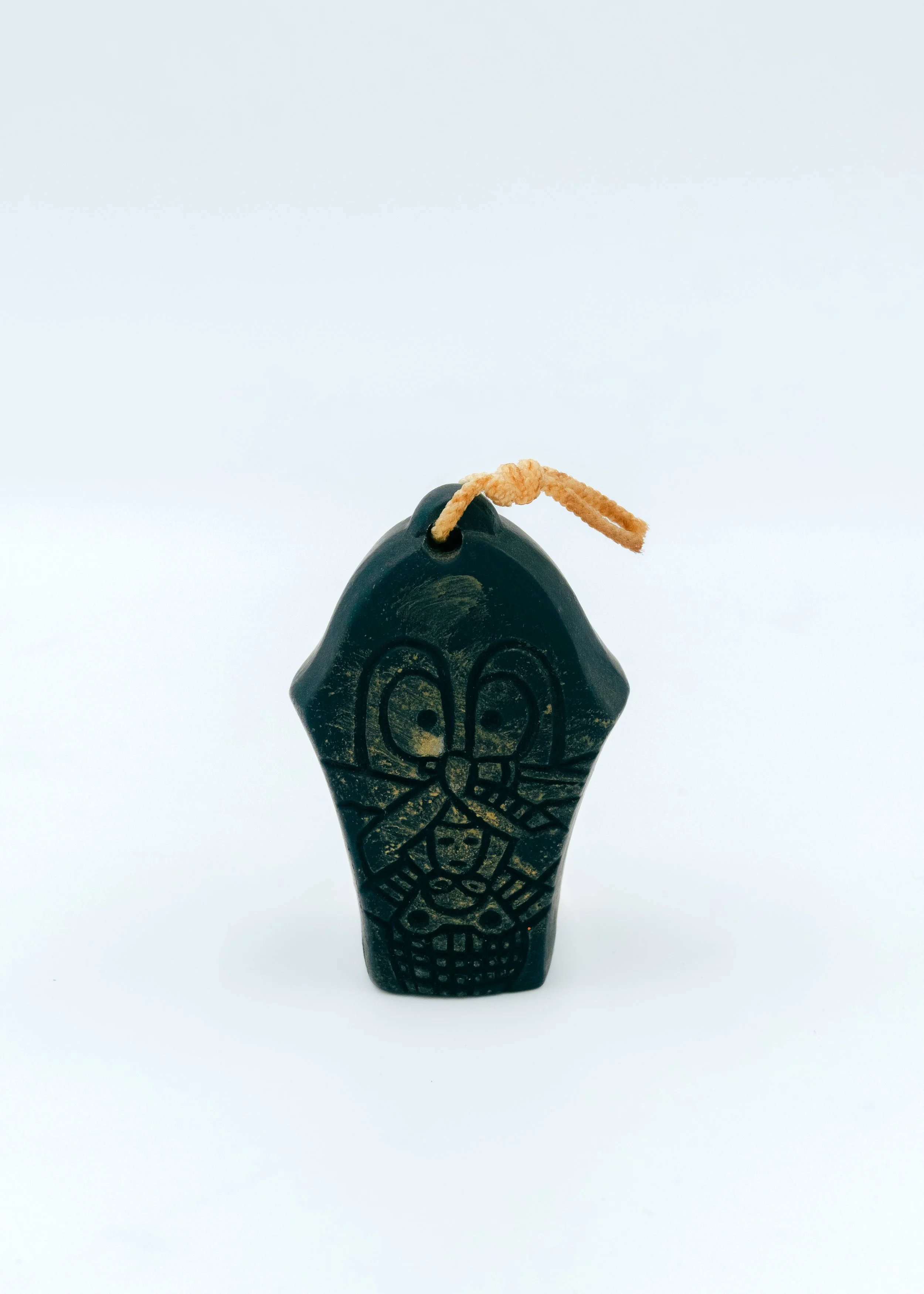 Side profile of a Japanese ritual bell mascot (Dorei), showing the primitive yet sophisticated sculptural depth of the 500-year-old Hirado kite-art tradition.