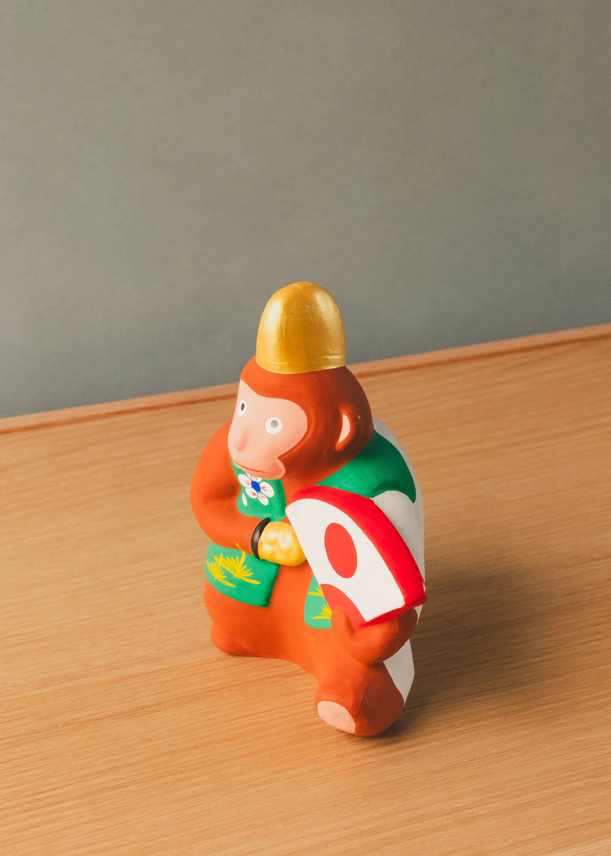 Hanamaki Ningyo clay monkey figurine. 1974 Japanese folk craft (Mingei) showcasing vibrant hand-painted robes and a celebratory fan.