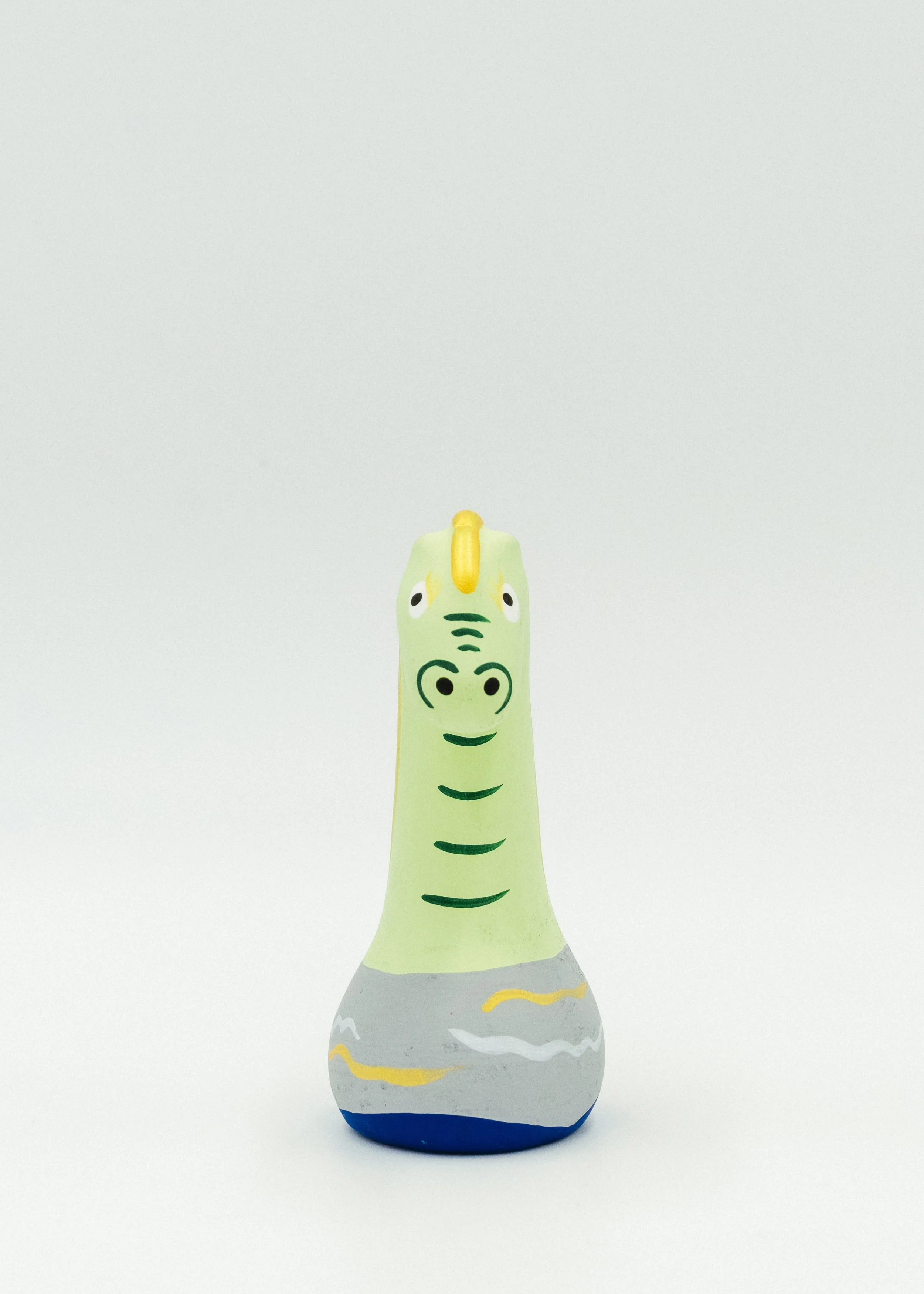 Front view of funny face Japanese clay dragon doll minimal design Obata deko primitive sculpture