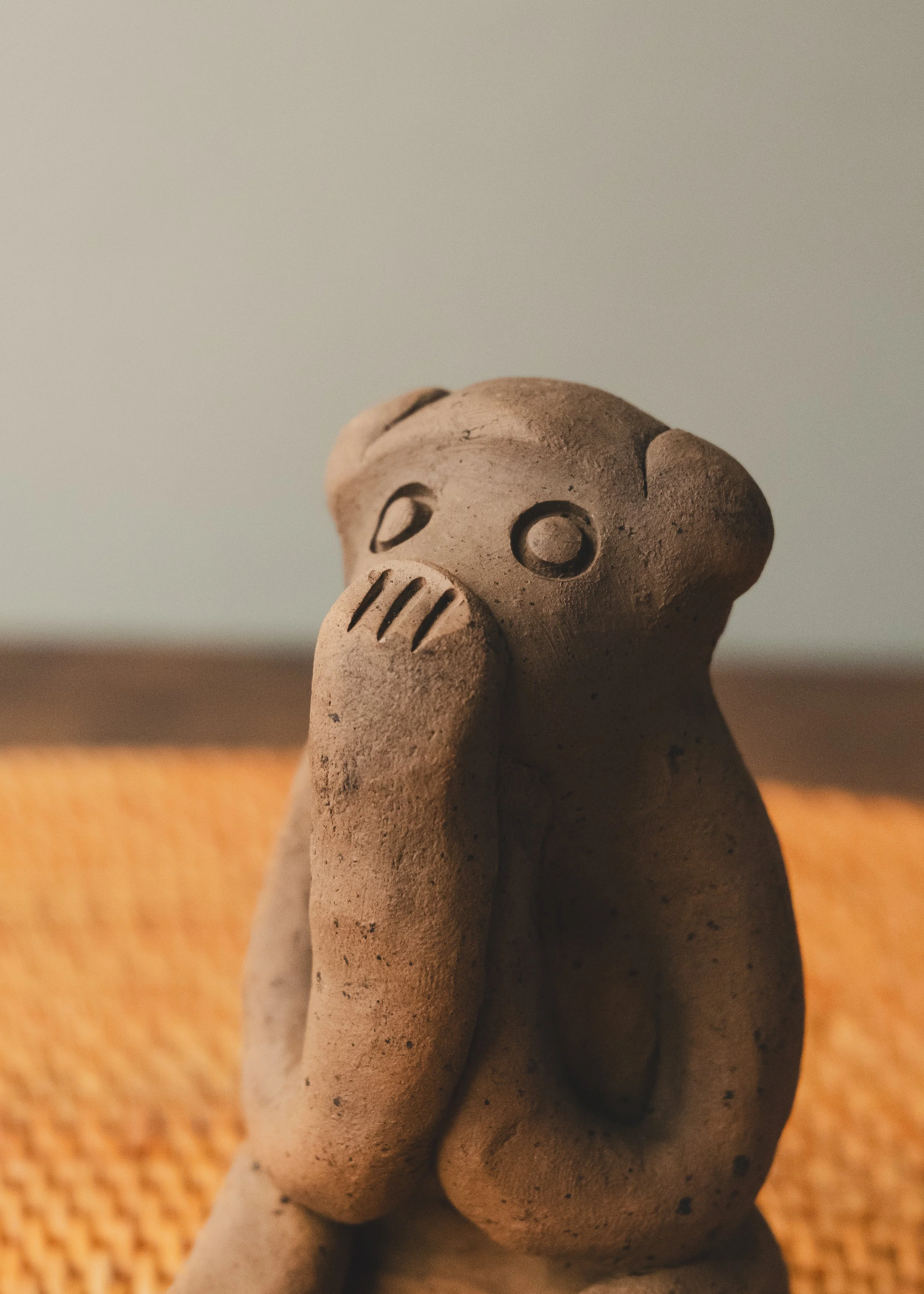 Vintage Japanese folk art "Speak No Evil" monkey talisman. The Brutalist and minimalist clay form functions as an intellectual conversation piece for contemporary desktop styling.