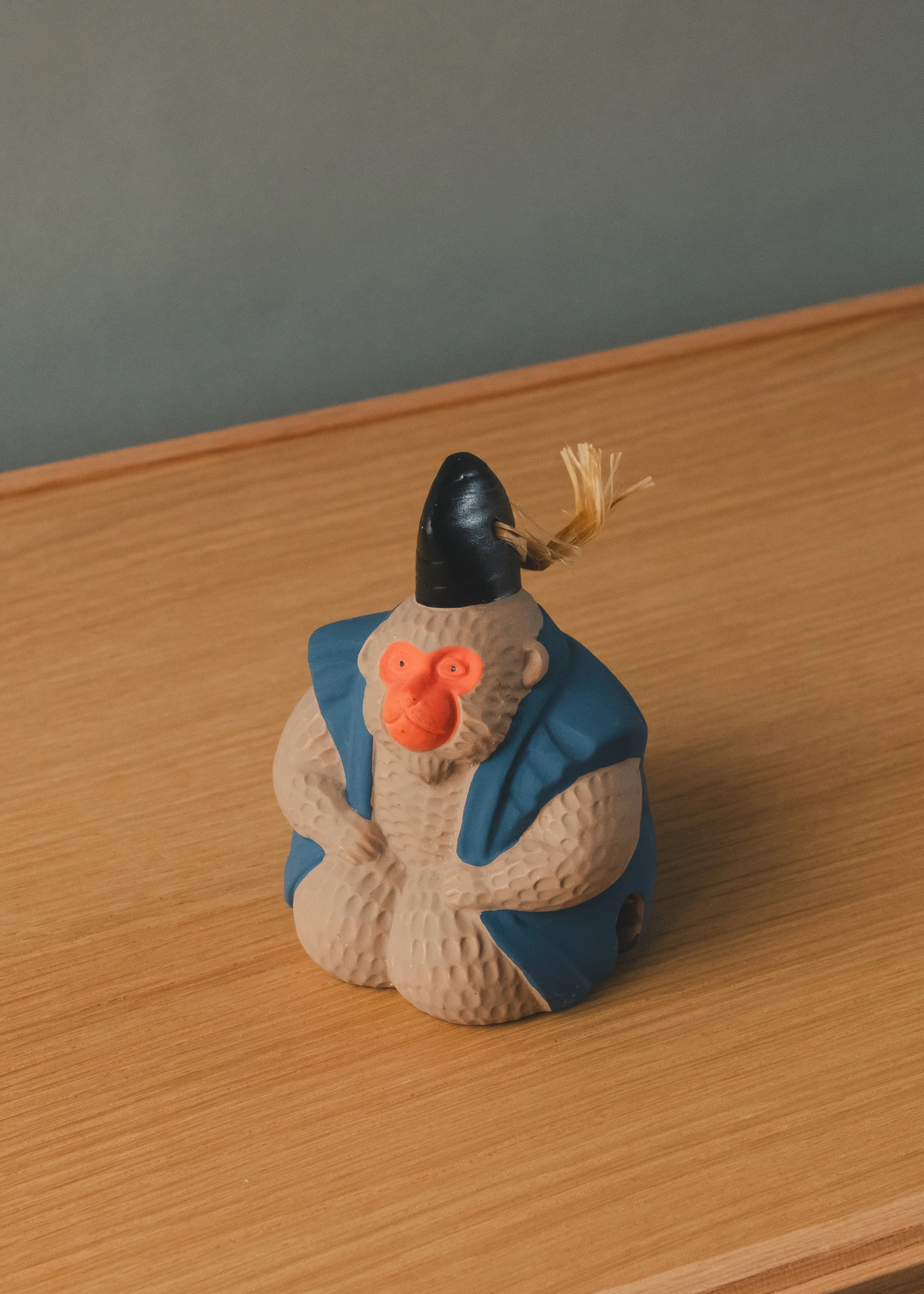 Azure Herald: Vintage clay monkey ritual bell from Osaka Tenmangu Shrine. A spiritual utility for the modern desk, representing protection and academic wisdom.