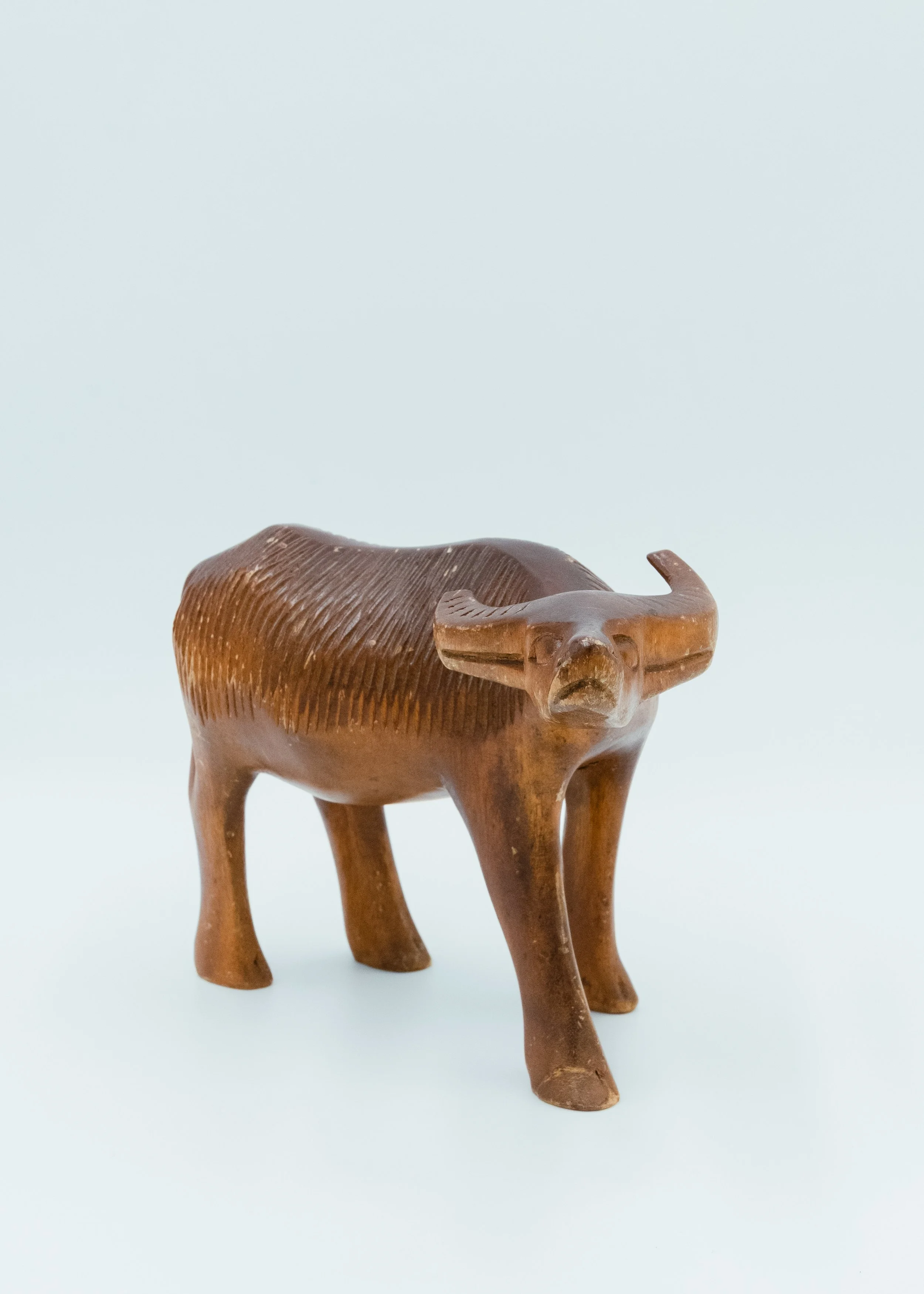 Front face view of rustic wooden animal sculpture Japanese primitive buffalo figure wabi-sabi decor