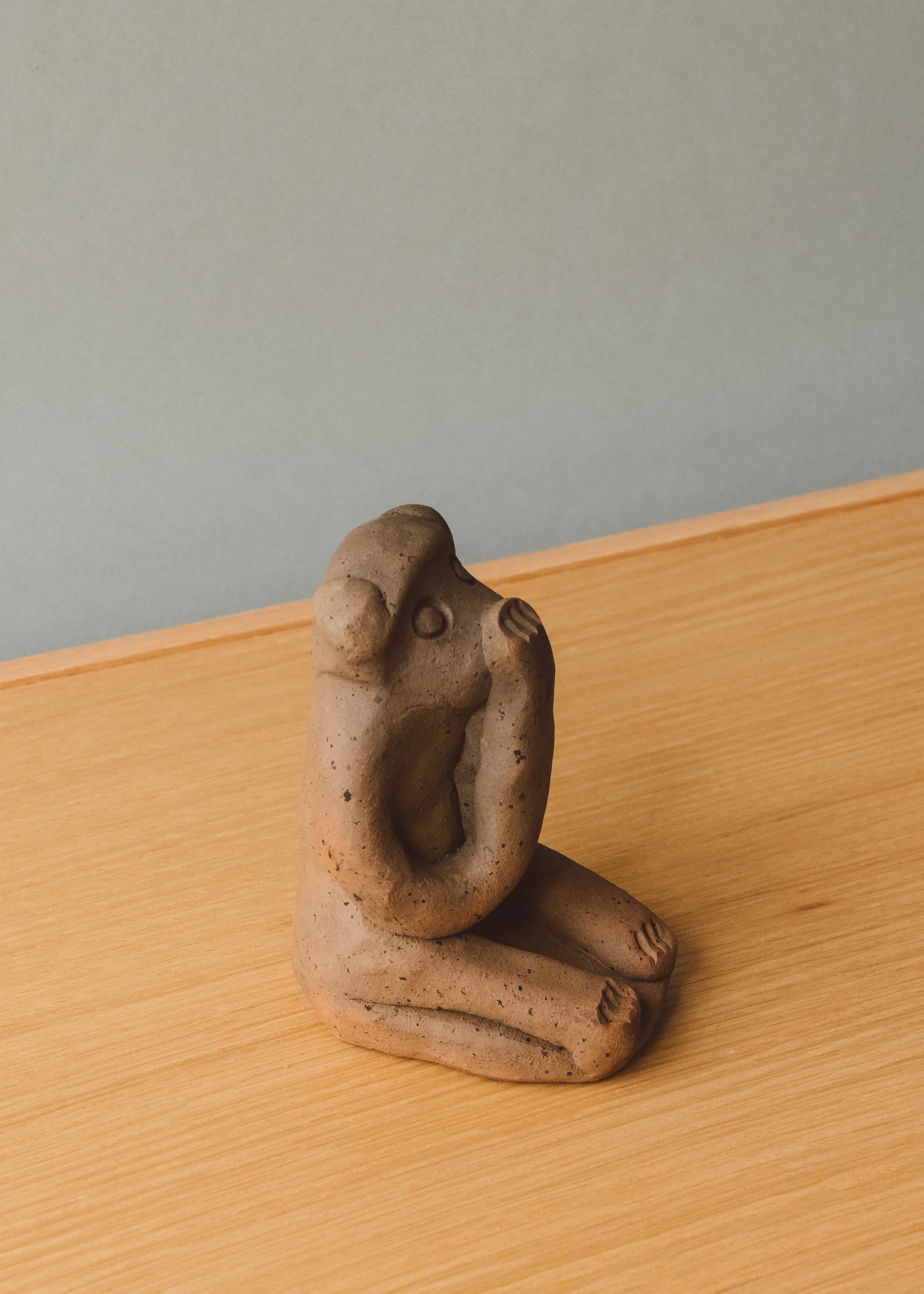 Vintage Japanese folk art "Speak No Evil" monkey talisman. The Brutalist and minimalist clay form functions as an intellectual conversation piece for contemporary desktop styling.