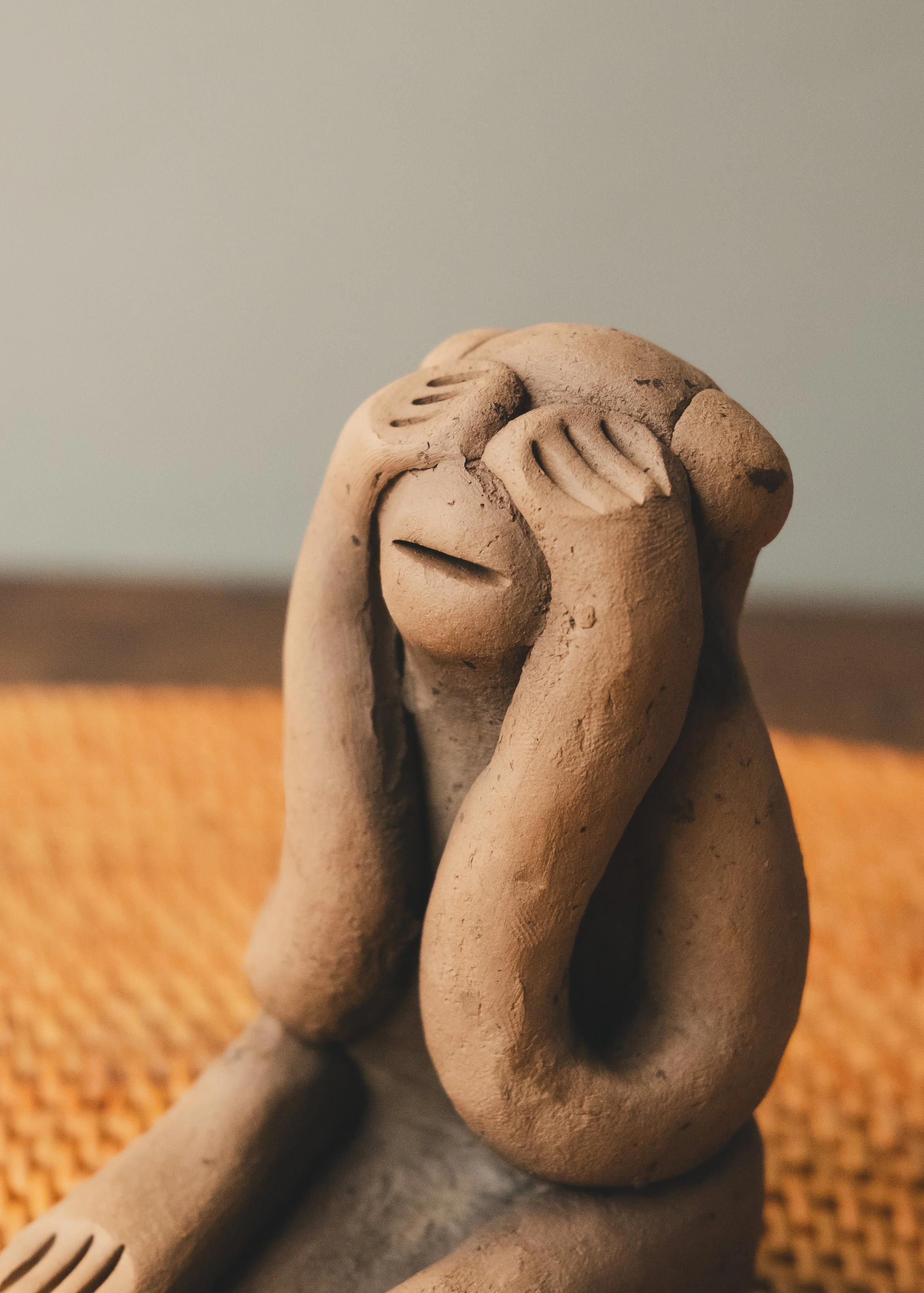 Close up of a 1960s Japanese clay guardian monkey (See No Evil). Features a rugged, finger-pinched surface characteristic of primitive Zen aesthetics, sourced from an authentic Mingei archive.