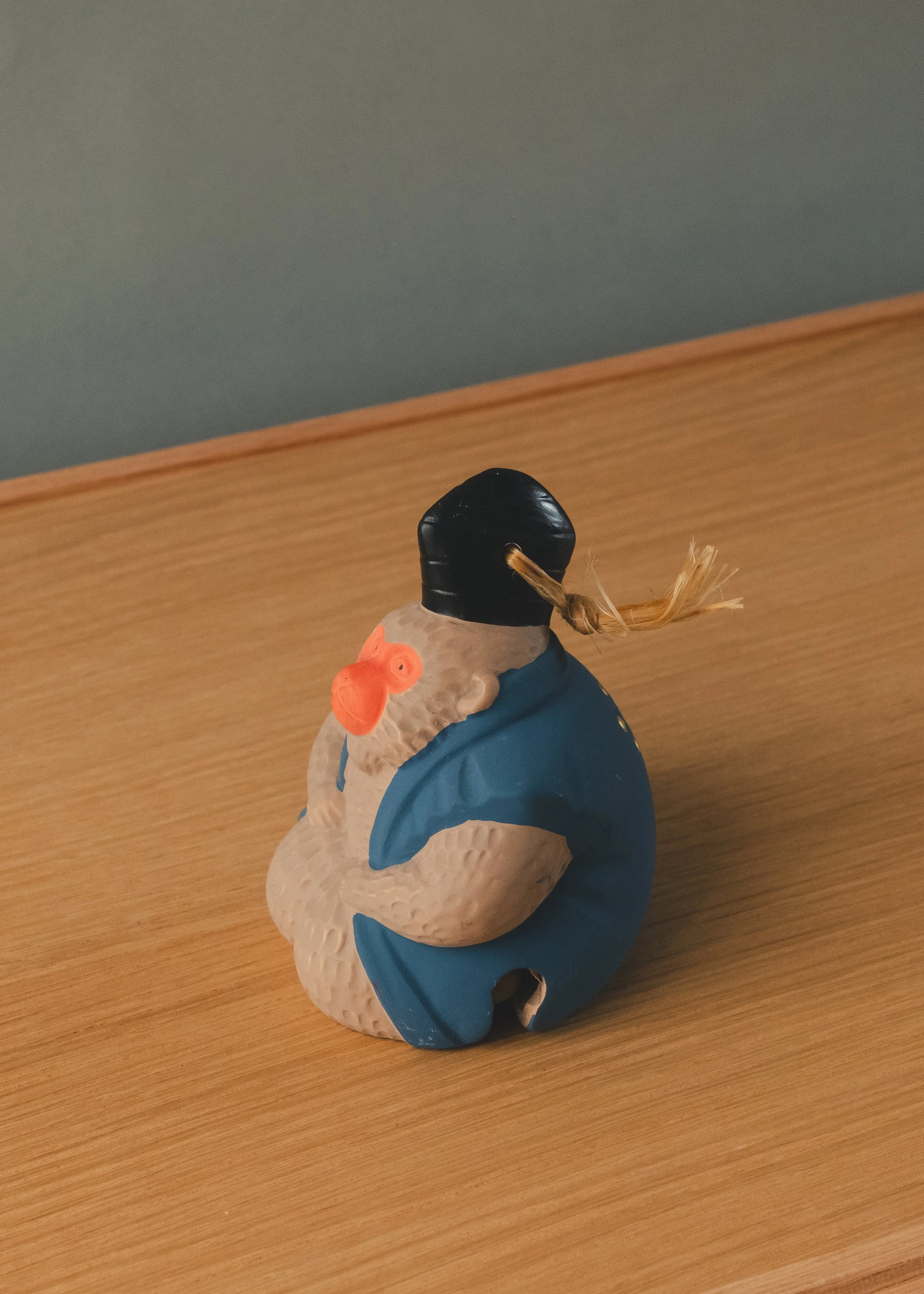 Side profile of a Japanese temple herald wearing an Eboshi (shrine hat). A tactile archival specimen with a silent expression of 1,500 years of cultural weight.