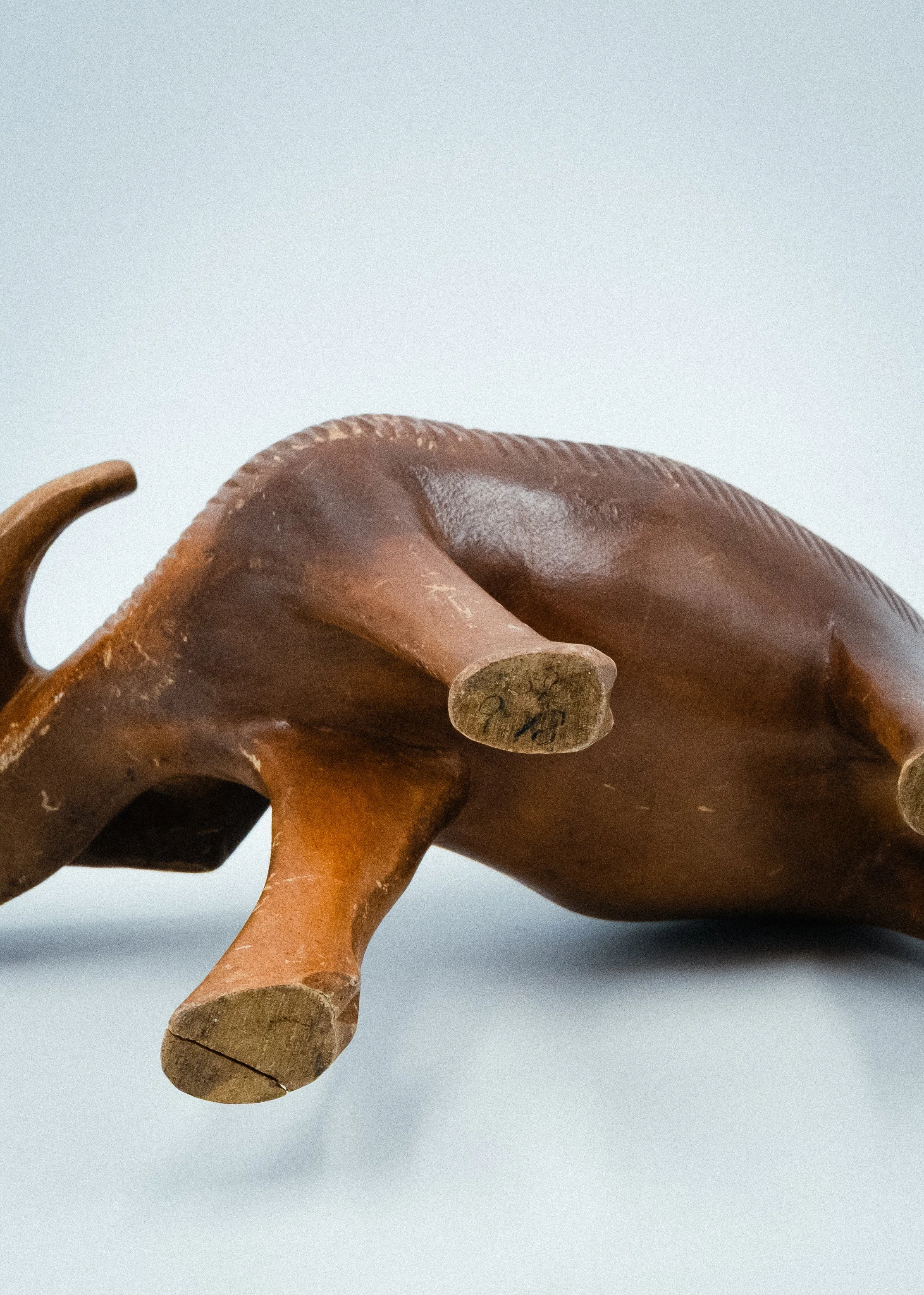 Bottom view of vintage Ainu wood carving water buffalo statue signed by artist authentic indigenous art