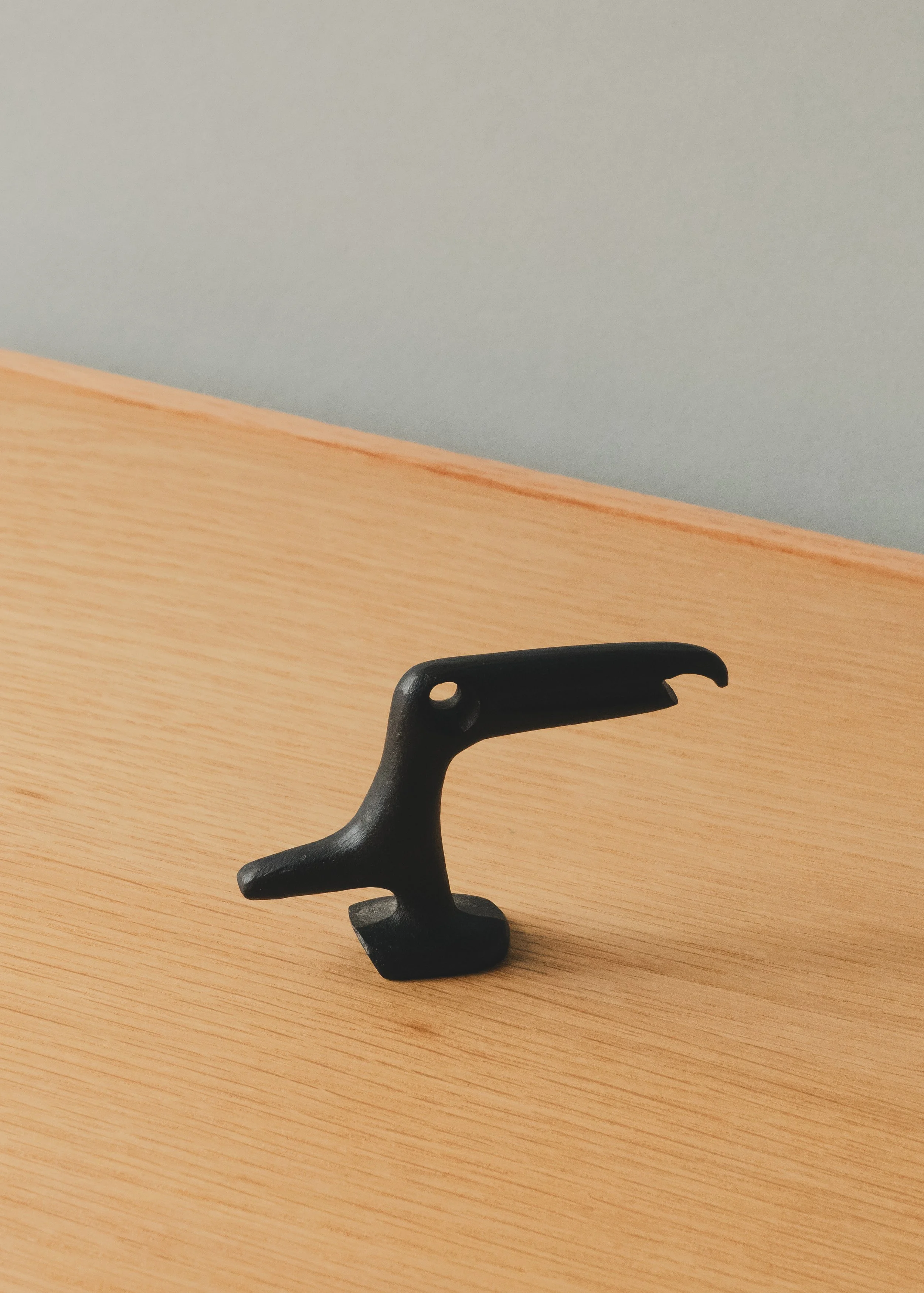 Perspective view of FERROUS RAVEN 1970 (Vertical), showing the textured matte black surface and hand-cast material integrity of authentic Nambu Tekki from Iwate, Japan.