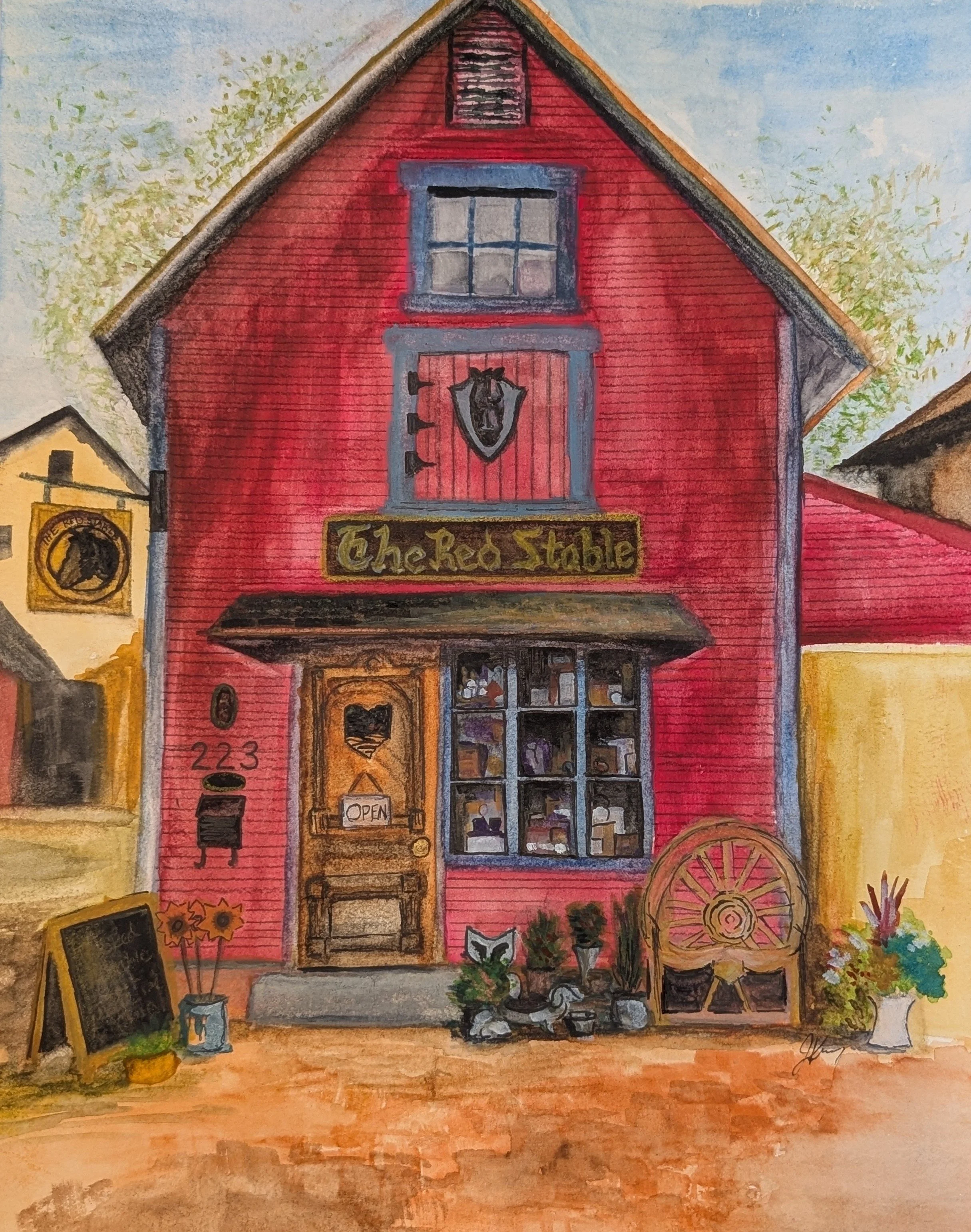 A colorful watercolor painting of a red barn with a sign that reads "The Red Stable." The barn has a window and a door, with decorative items outside including sunflowers and a wheel. The scene also includes a yellow building with a sign featuring a horse, and an outdoor chalkboard sign, plants, and flowers.