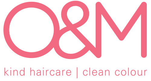 Logo for Q&M haircare, featuring pink text that reads 'Q&M' with the tagline 'kind haircare | clean colour' beneath.