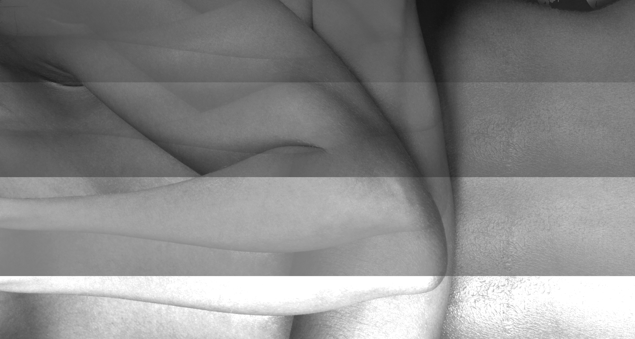 Close-up of intertwined fingers in grayscale.