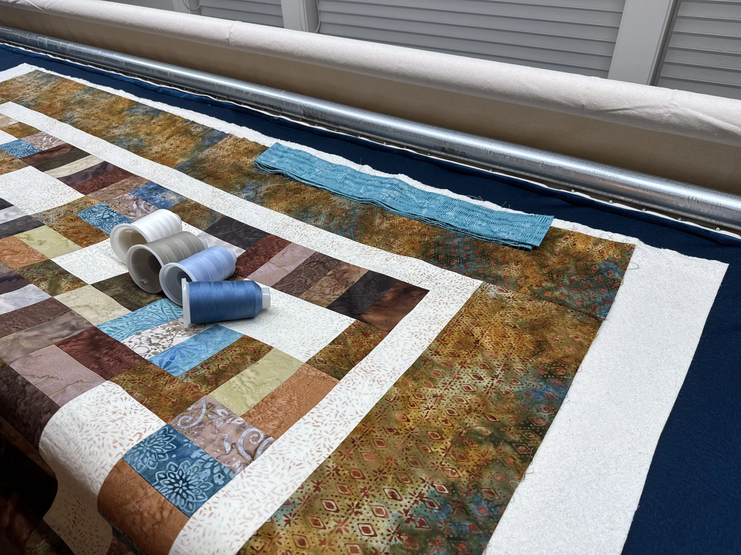 Jonee's Batik quilt.   Edge to Edge with Machine Attach Binding and Hand Binding