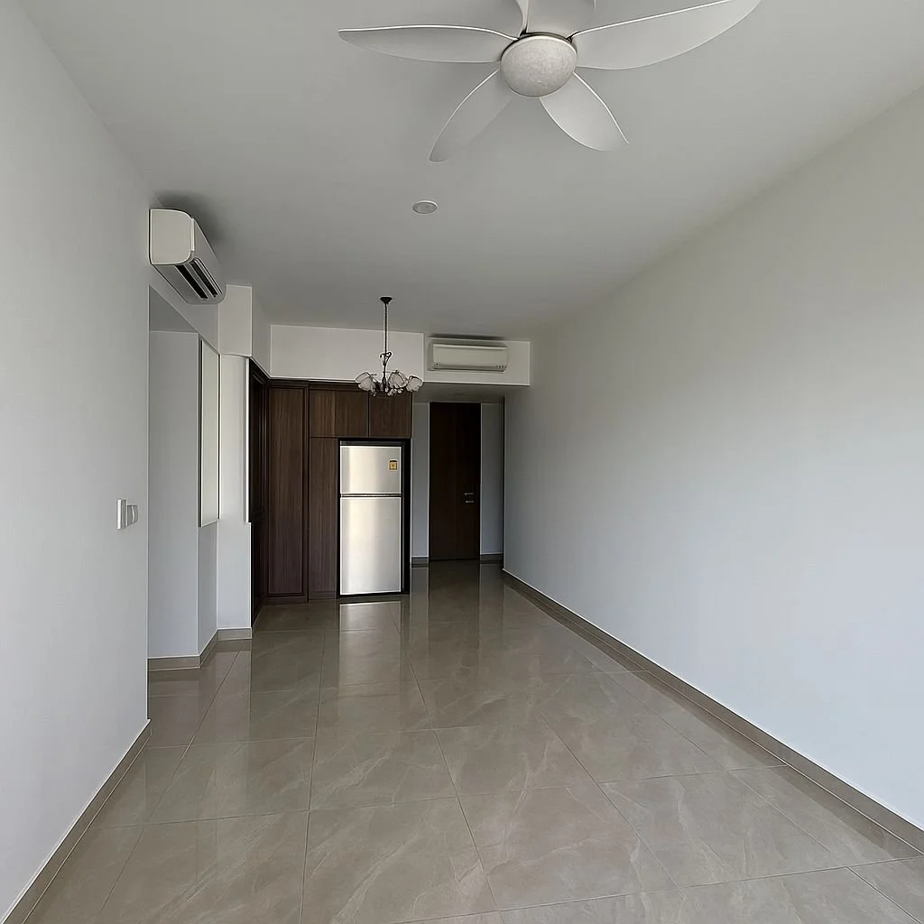 Empty room with beige tiled floor, white walls, a ceiling fan, an air conditioning unit, a small chandelier, and a kitchen area with a stainless steel refrigerator and dark wood cabinets.