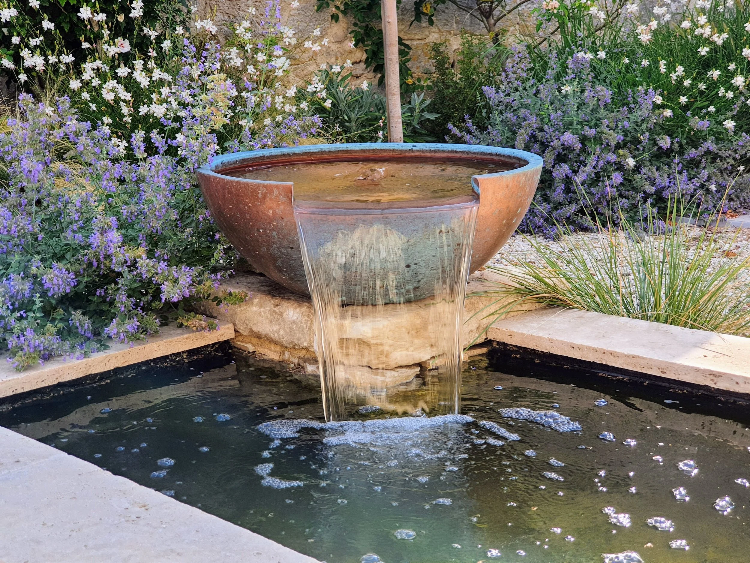 Copper bowl water feature in courtyard garden
