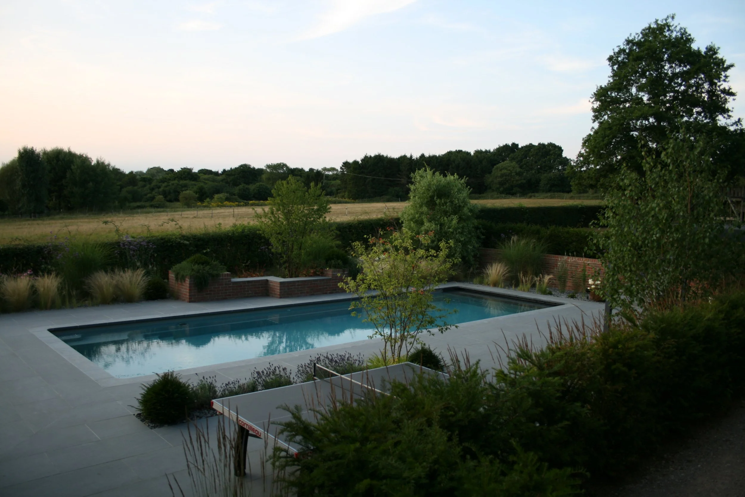 Porcelain paved pool terrace with integrated seating