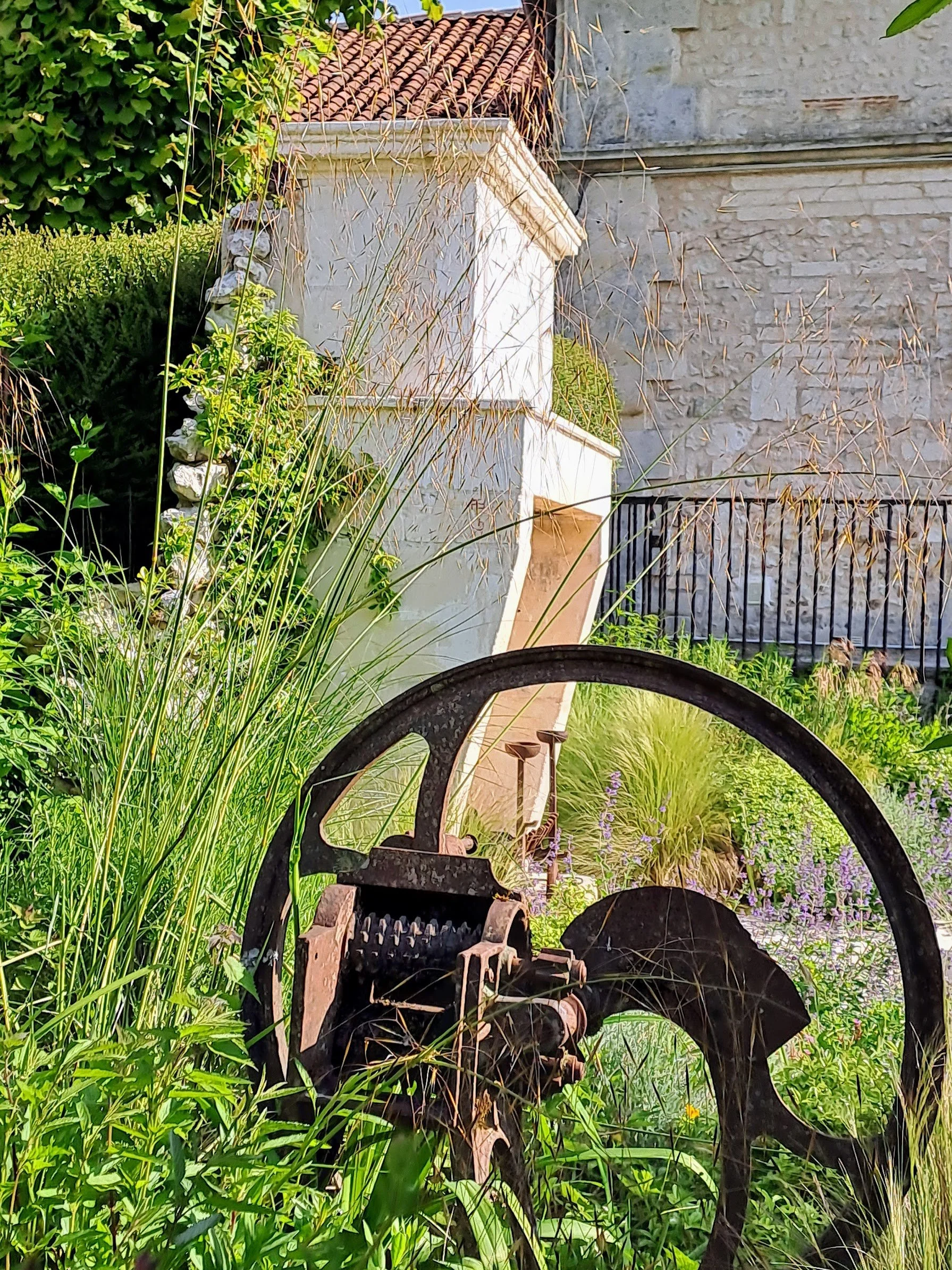 Reclaimed 19th century stone fireplace in garden