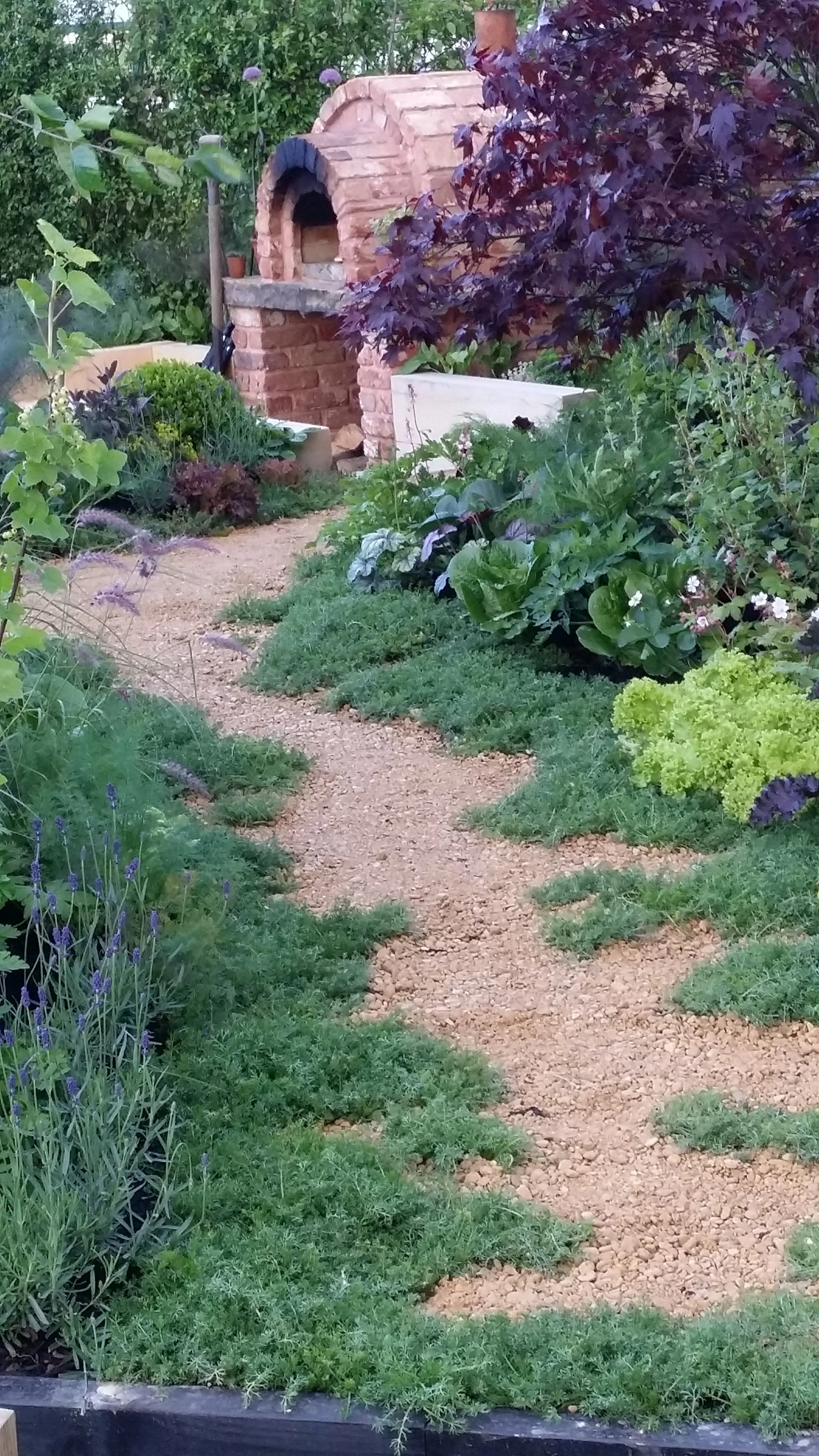 Wood-fired pizza oven integrated into a private garden design for a keen cook in the Charente, South West France