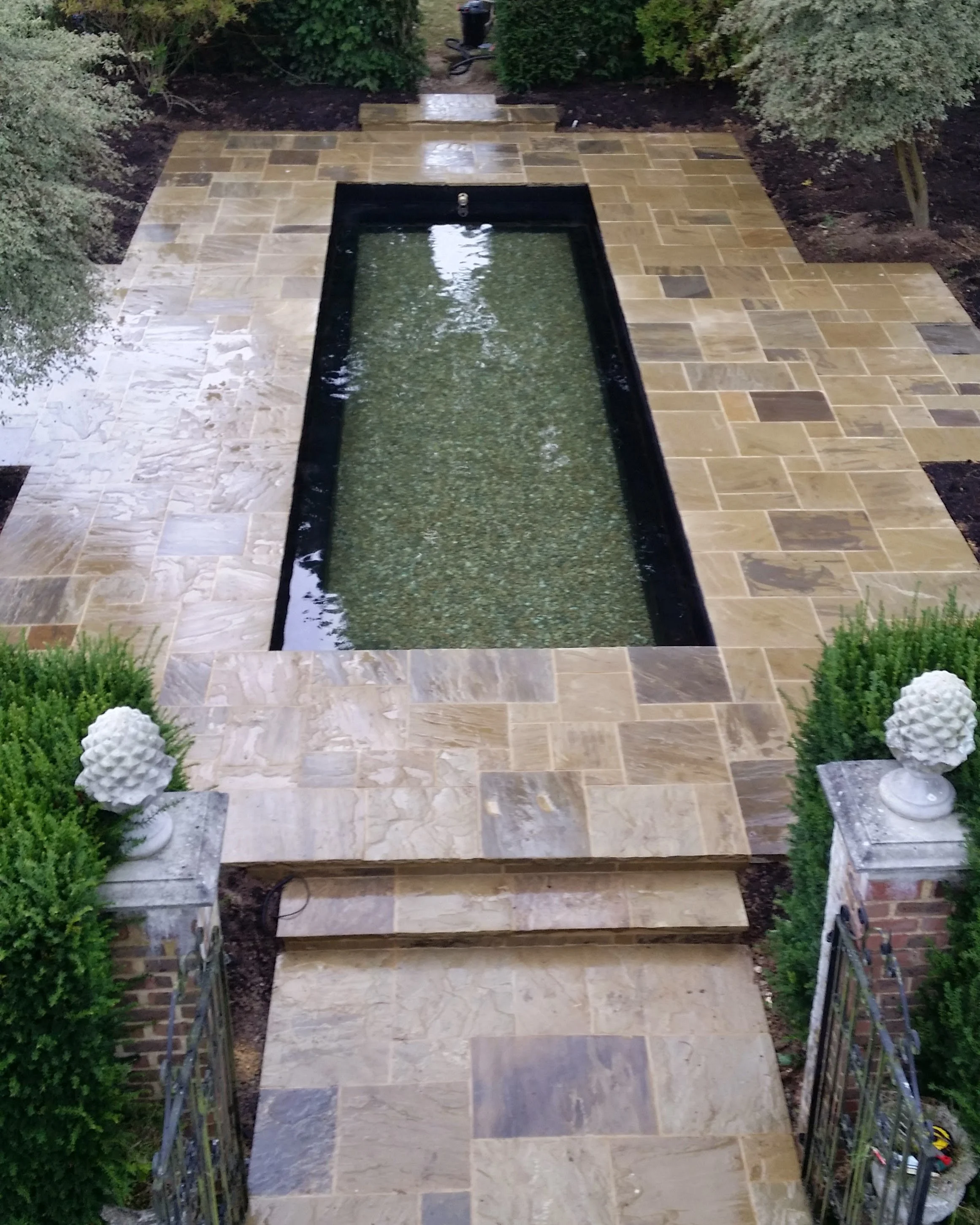 Italian-inspired garden design with ornamental pool with Mediterranean planting and structured layout in the Charente