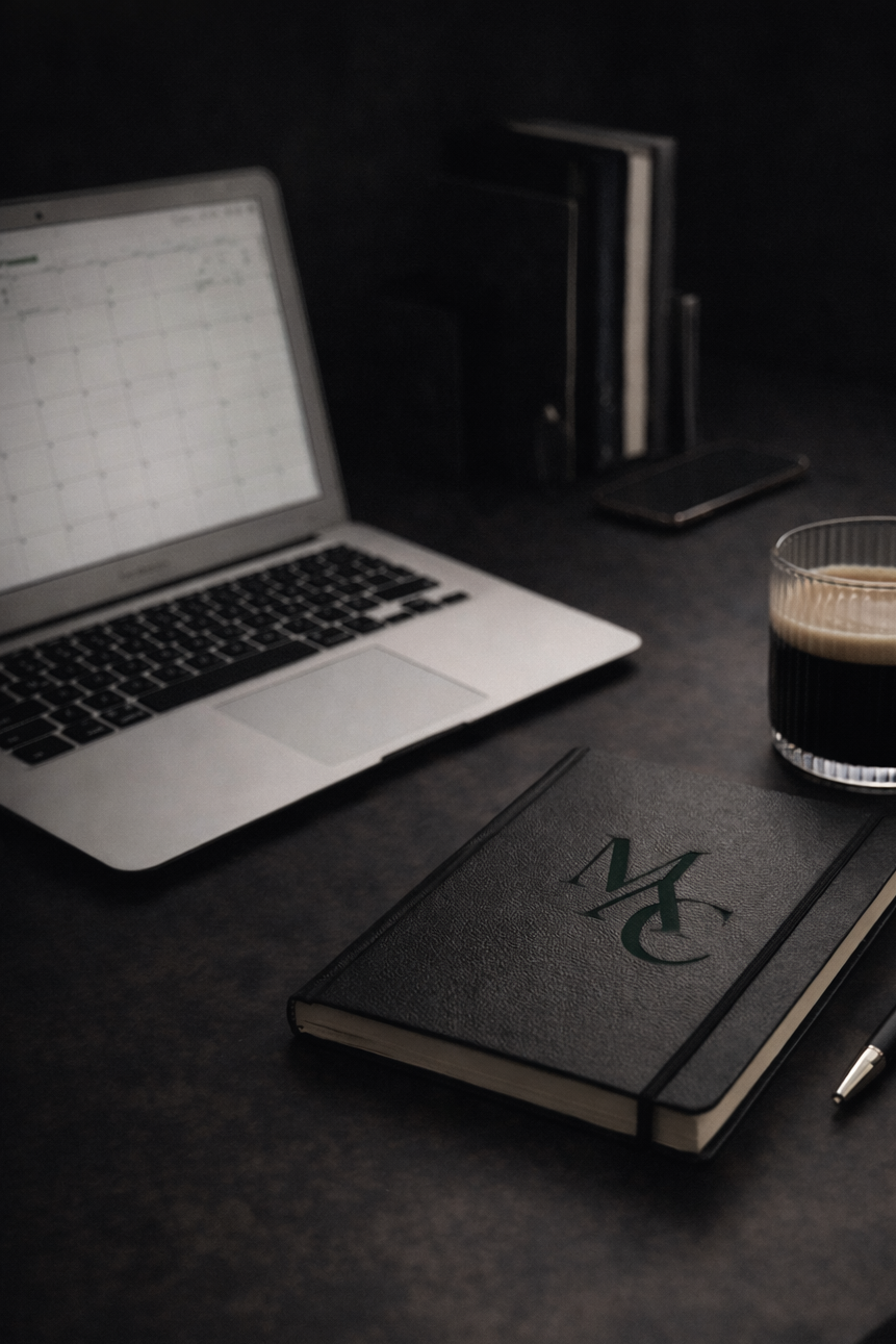 Executive assistant workspace with laptop, planner and coffee for business organisation