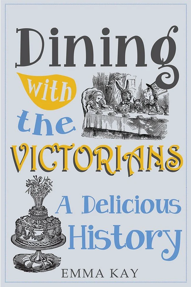 Book cover titled 'Dining with the Victorians: A Delicious History' by Emma Kay. The cover features a black and white illustration of a Victorian dinner scene with people and animals, and an ornate Victorian-style cake with flowers.