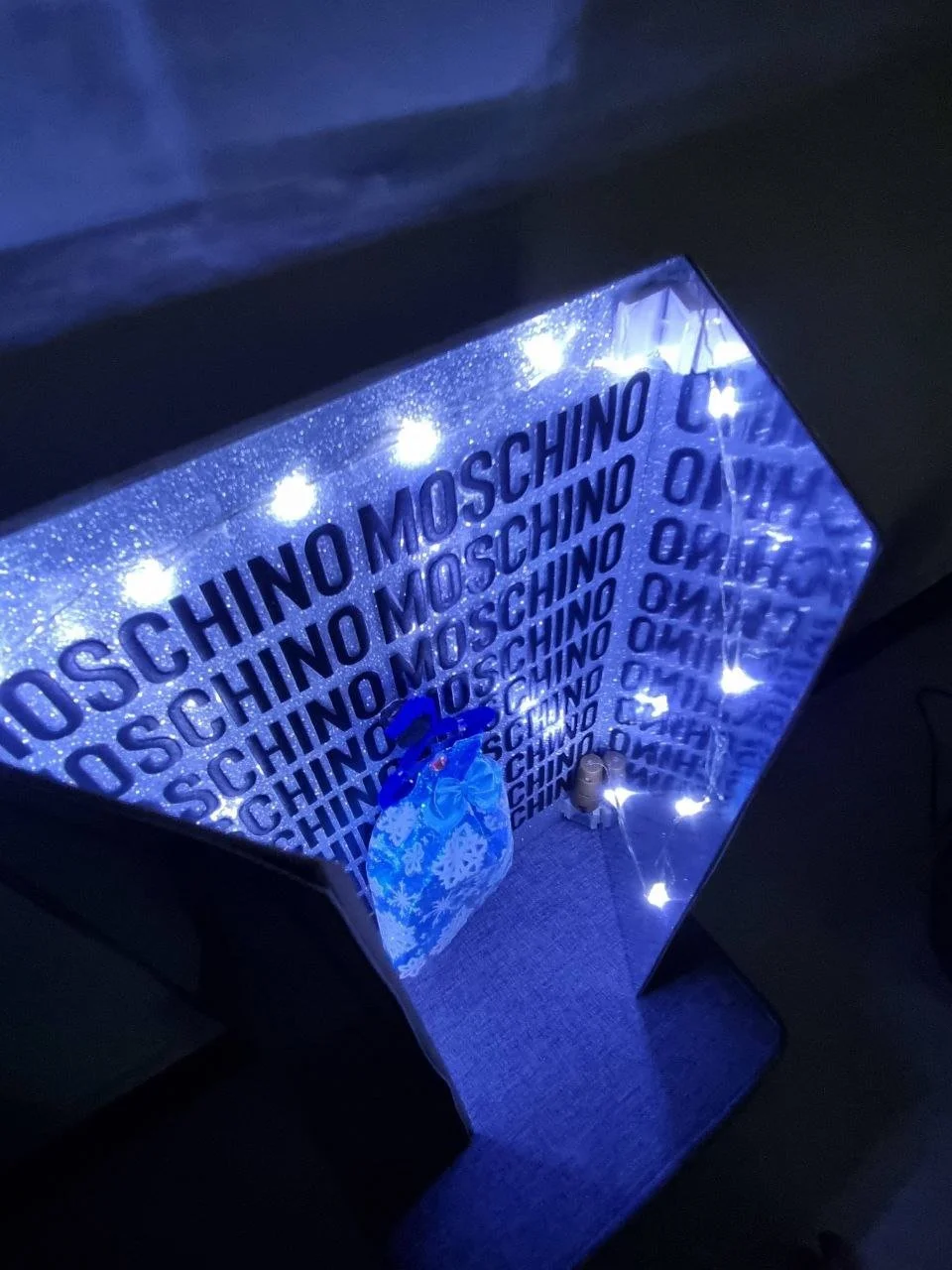 The display was designed as a three-dimensional wardrobe structure opened at a 45-degree angle, allowing viewers to engage with the piece from multiple perspectives while maintaining a clear focal point.