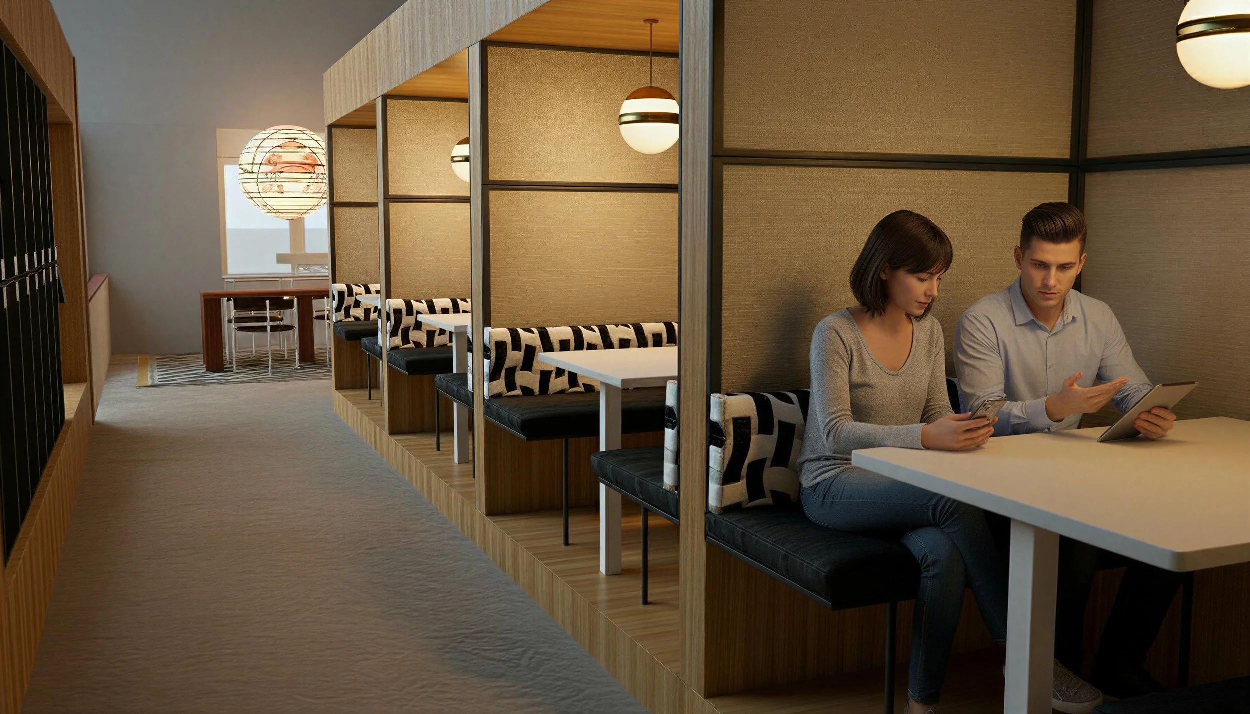 A modern cafe with a row of booth seating separated by wooden dividers, two people sitting and looking at their phones and a tablet at the table, with warm lighting and a patterned pillow on the booth seats.