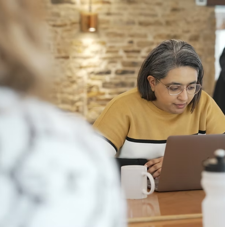 Opus team member working at laptop