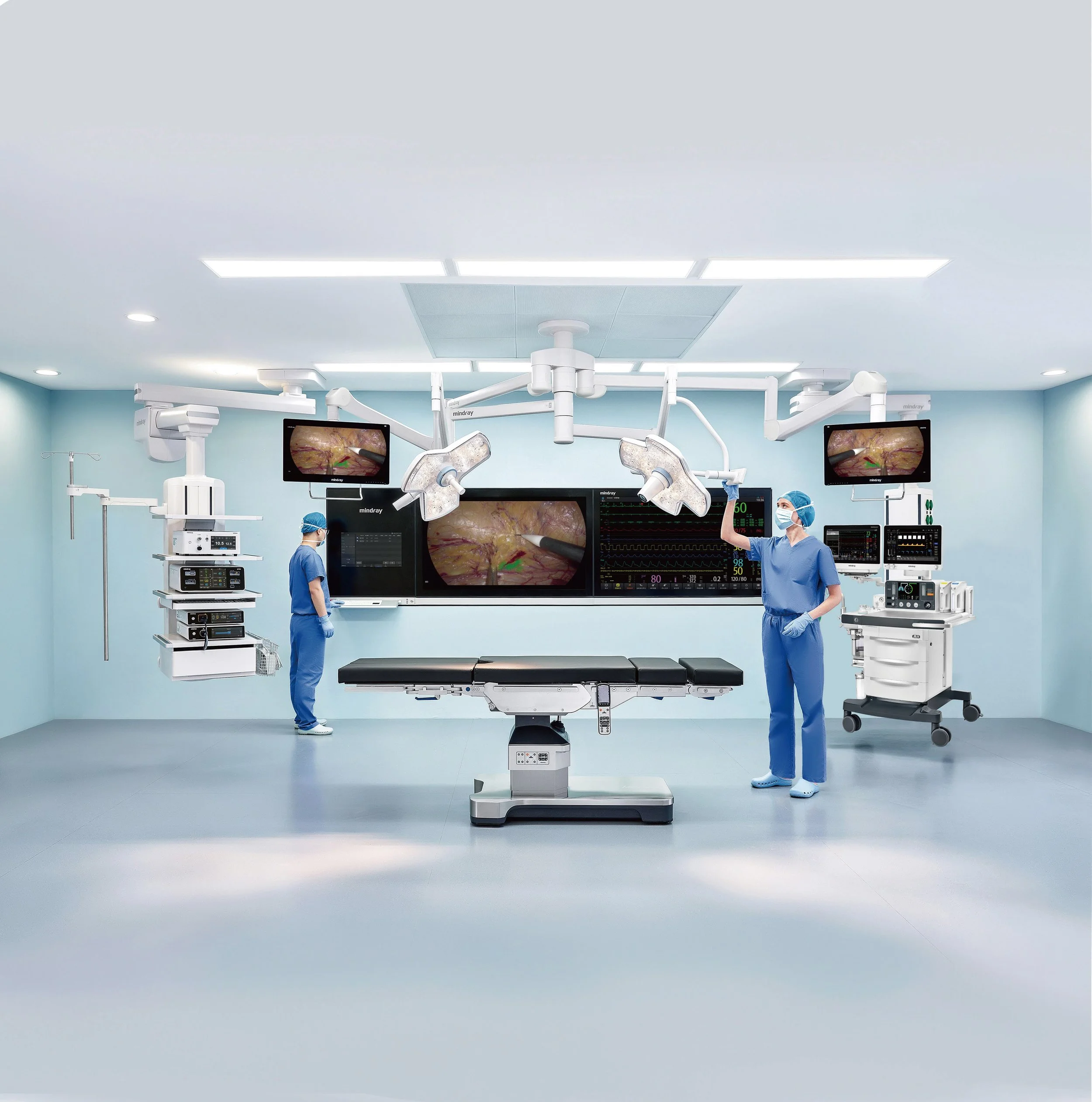 A modern operating room with medical staff and advanced surgical equipment, including monitors displaying medical images.