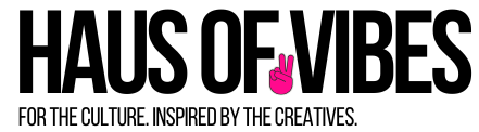 Pink hand making a peace sign gesture against a black background.