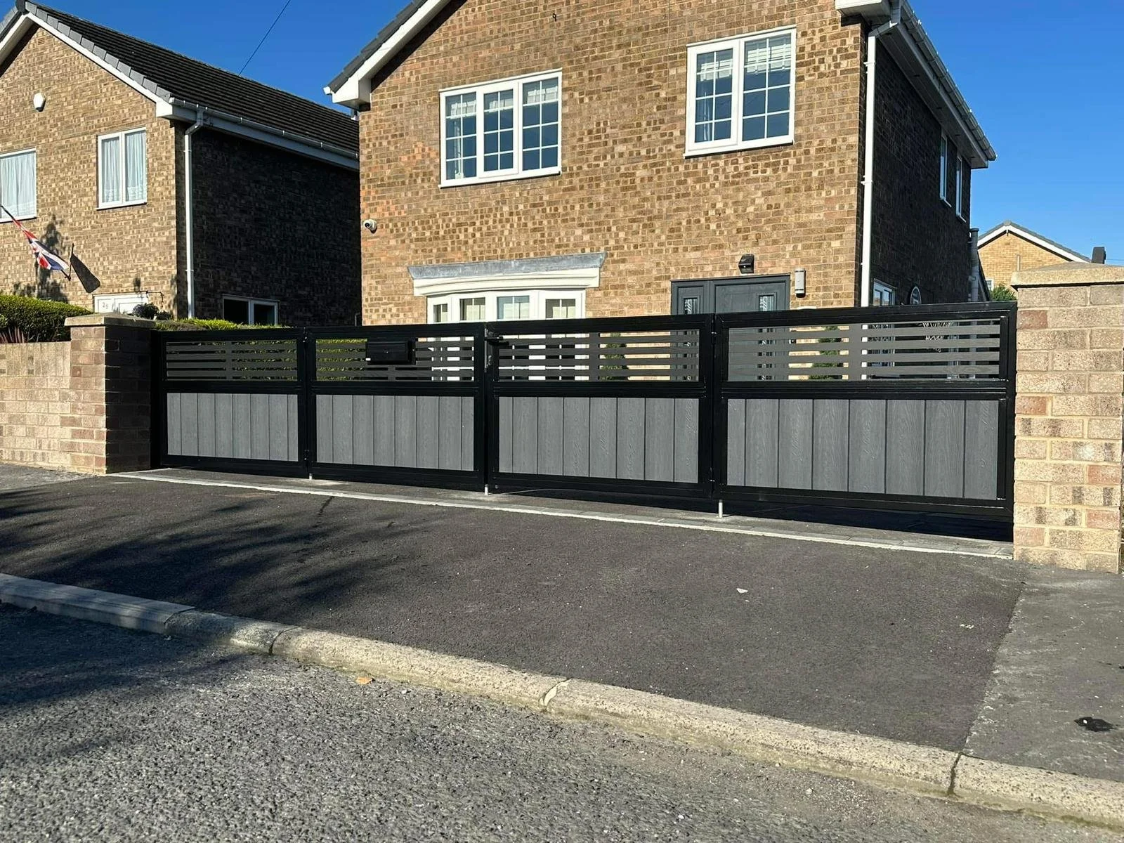 A bespoke bifolding driveway gate, Fabricated & installed by Whitworth Fabrications in Pontefract