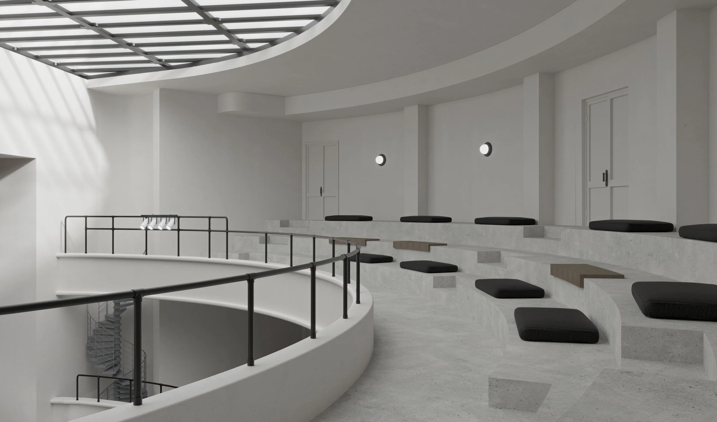 Interior of a modern, minimalist building with curved seating area and black cushions, metal railing, staircase, and circular wall lights.