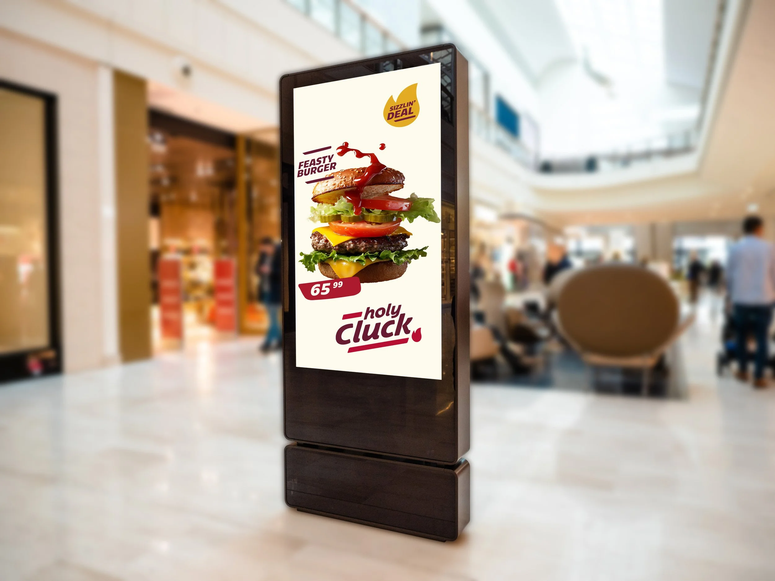 Digital advertising display in a shopping mall promoting a burger called "Feasty Burger" for $65.99, featuring an image of a multi-layered burger with lettuce, tomato, cheese, and a burger patty.