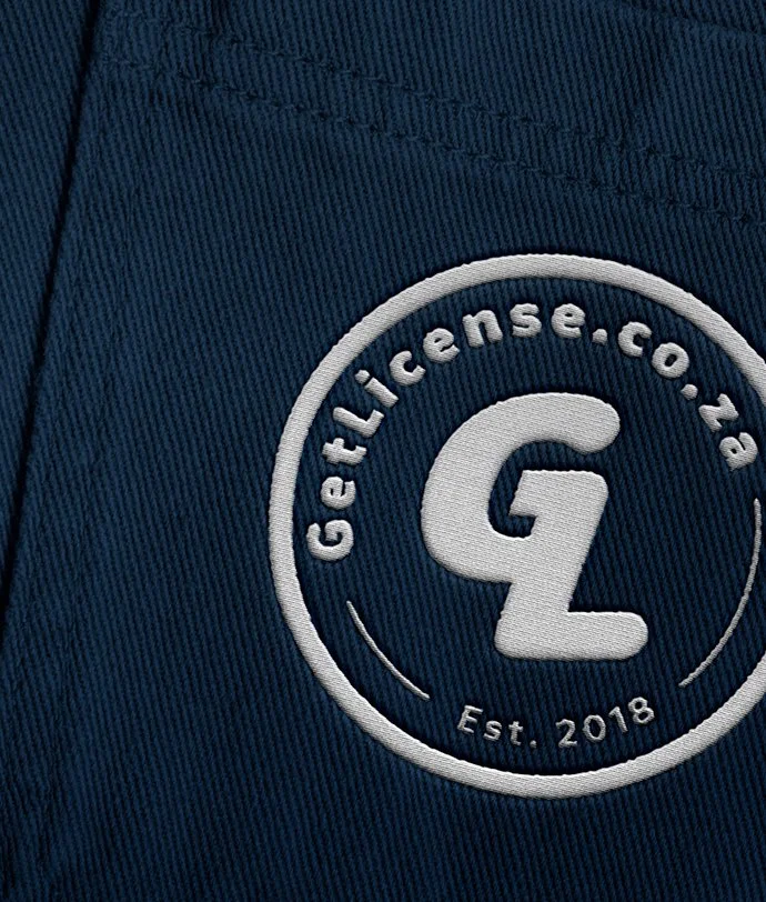 Close-up of a navy blue fabric with a circular embroidered logo that reads 'GetLicense.com' and 'Est. 2018' around a large letter 'G' and 'L' in the center.