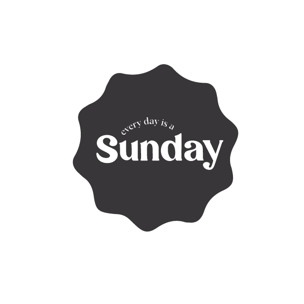 Graphic design with the phrase "Sunday" inside a dark gray, irregular shape. The phrase "enjoy the day" appears above "Sunday" in smaller text.